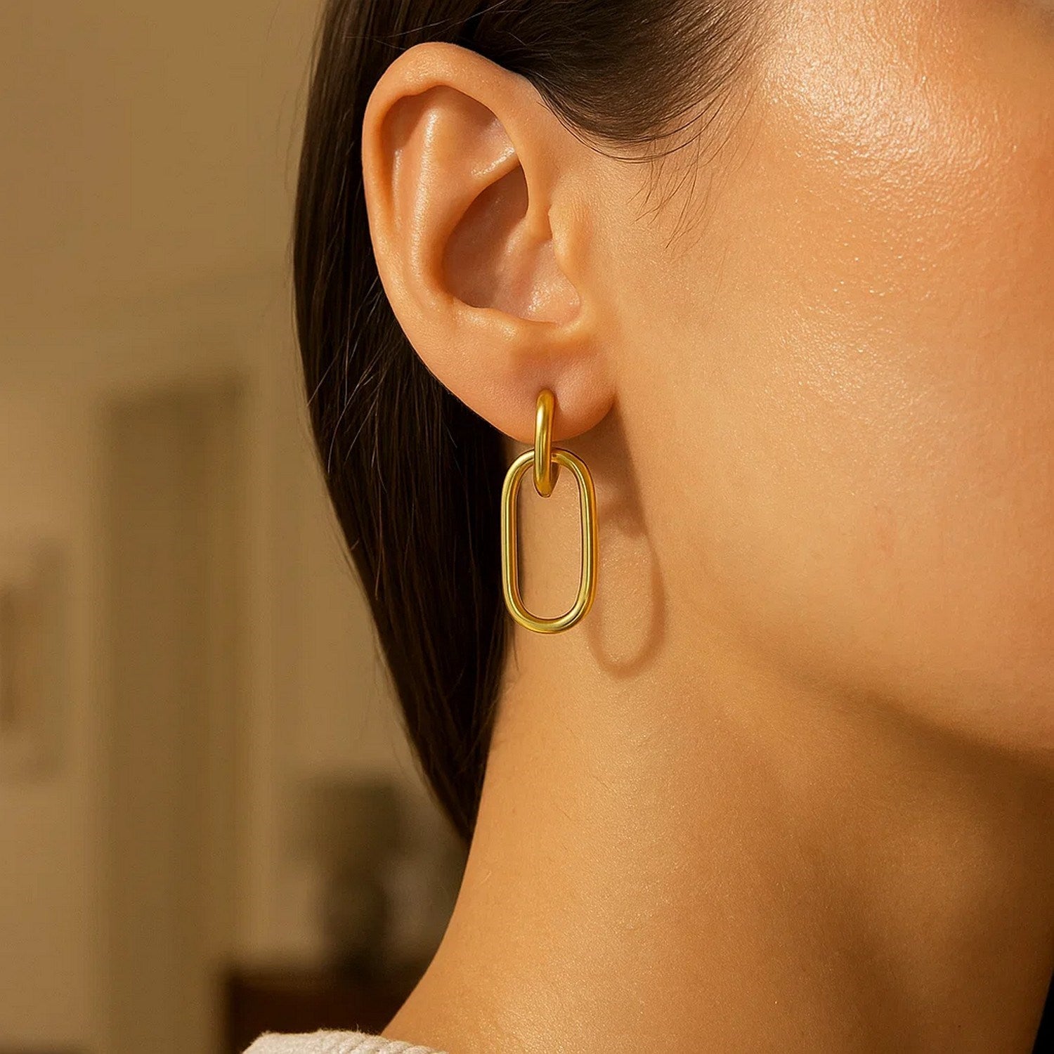 14K yellow gold polished oval linked hoop earrings, showcasing a modern design with elegant shine and sophistication.