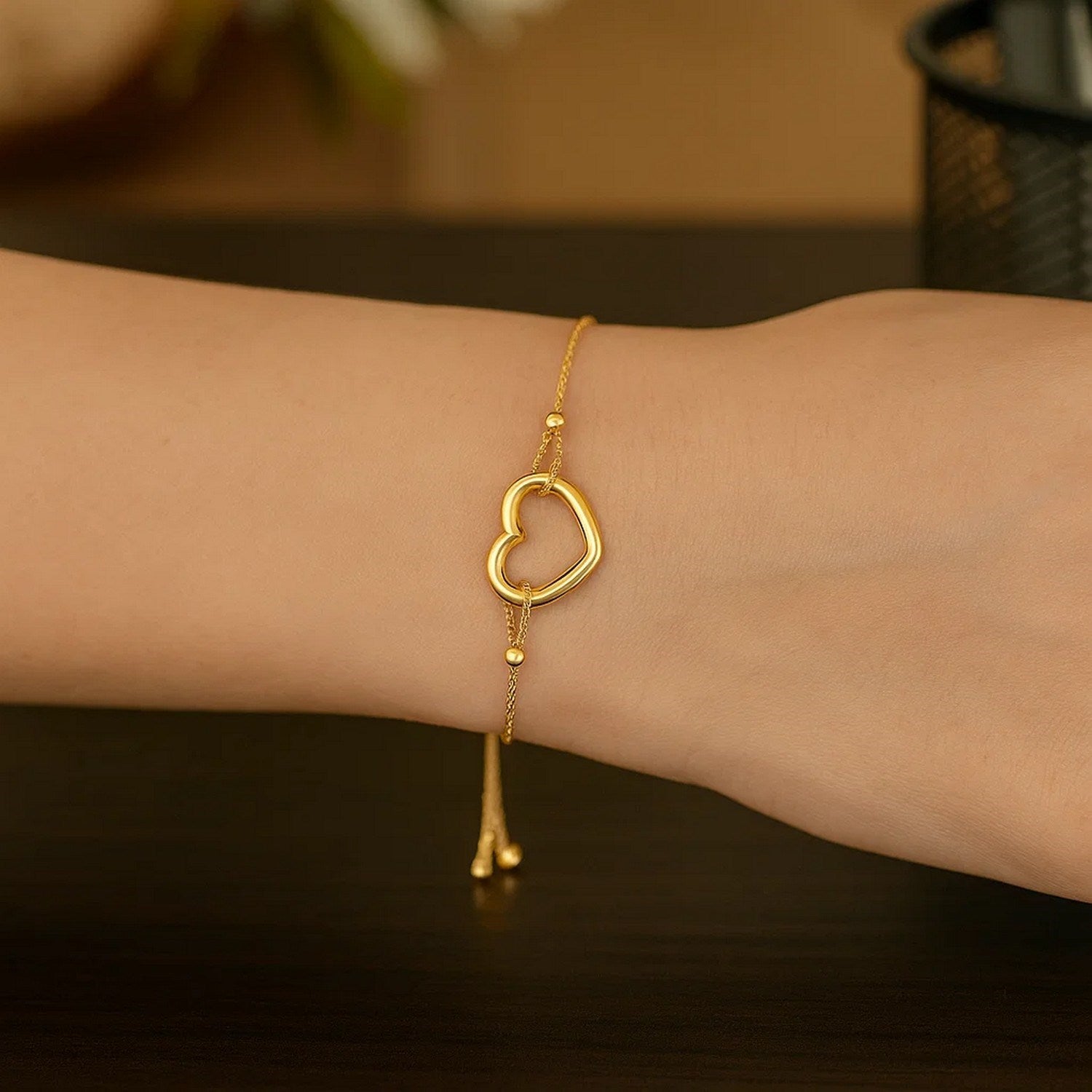 Adjustable 14k yellow gold bracelet featuring a modern shiny open heart design, perfect for luxury jewelry enthusiasts.