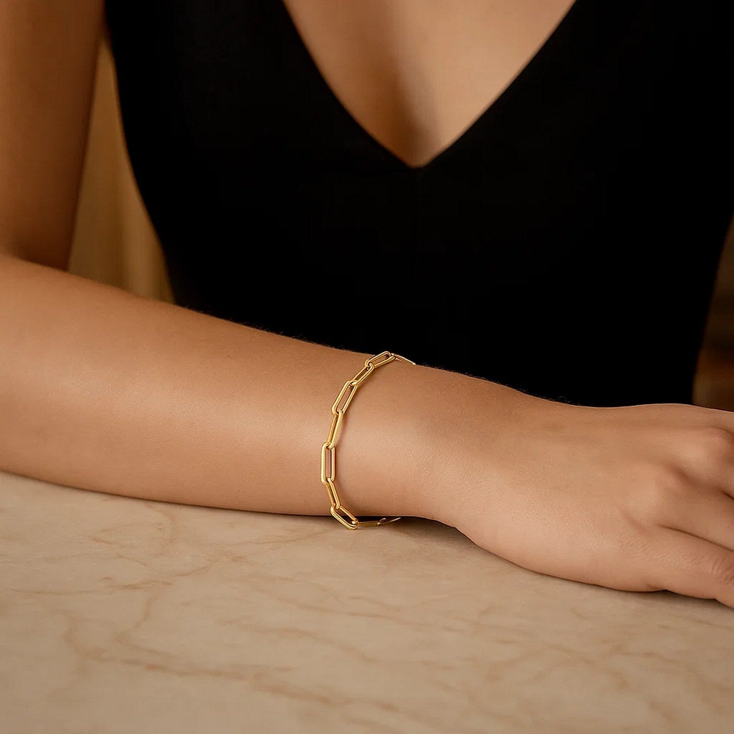 14k yellow gold bold paperclip chain bracelet featuring modern design and sleek, rounded links for a luxurious touch.