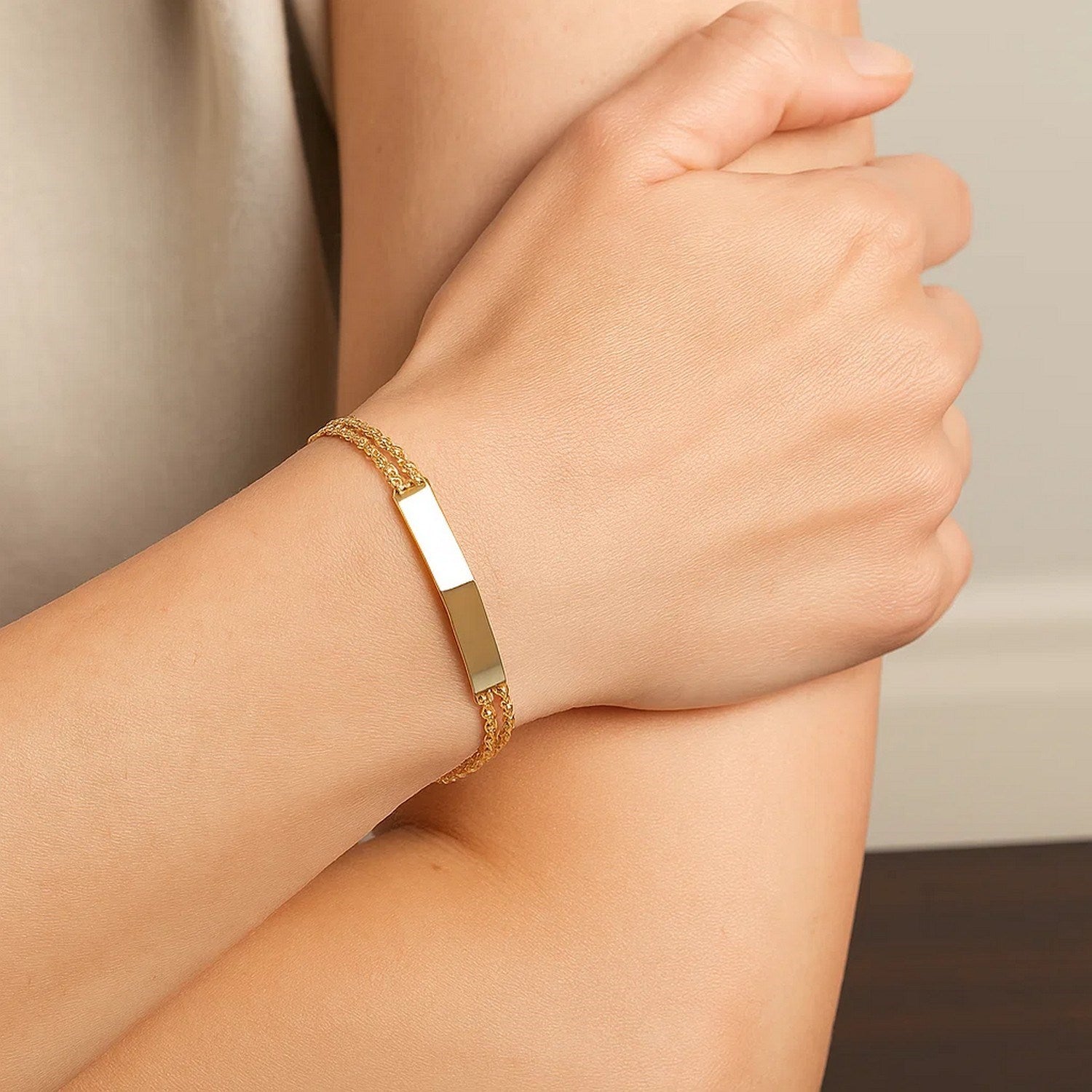 14k yellow gold minimalist ID bracelet with double rope chain, showcasing elegant craftsmanship and timeless style.