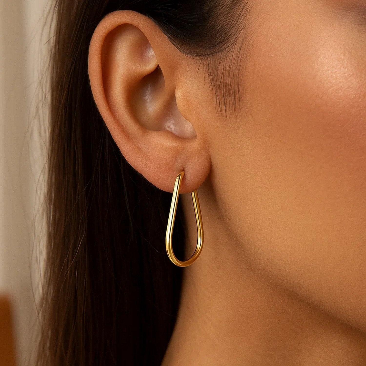 14k yellow gold endless pear hoop earrings exuding elegance with a timeless design and luxurious finish.