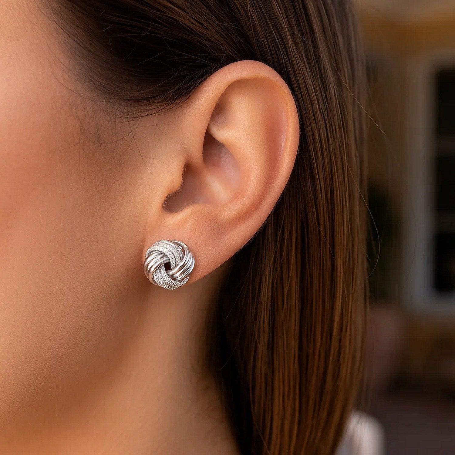 14k white gold polished love knot earrings with a contemporary design, perfect for elegant occasions.