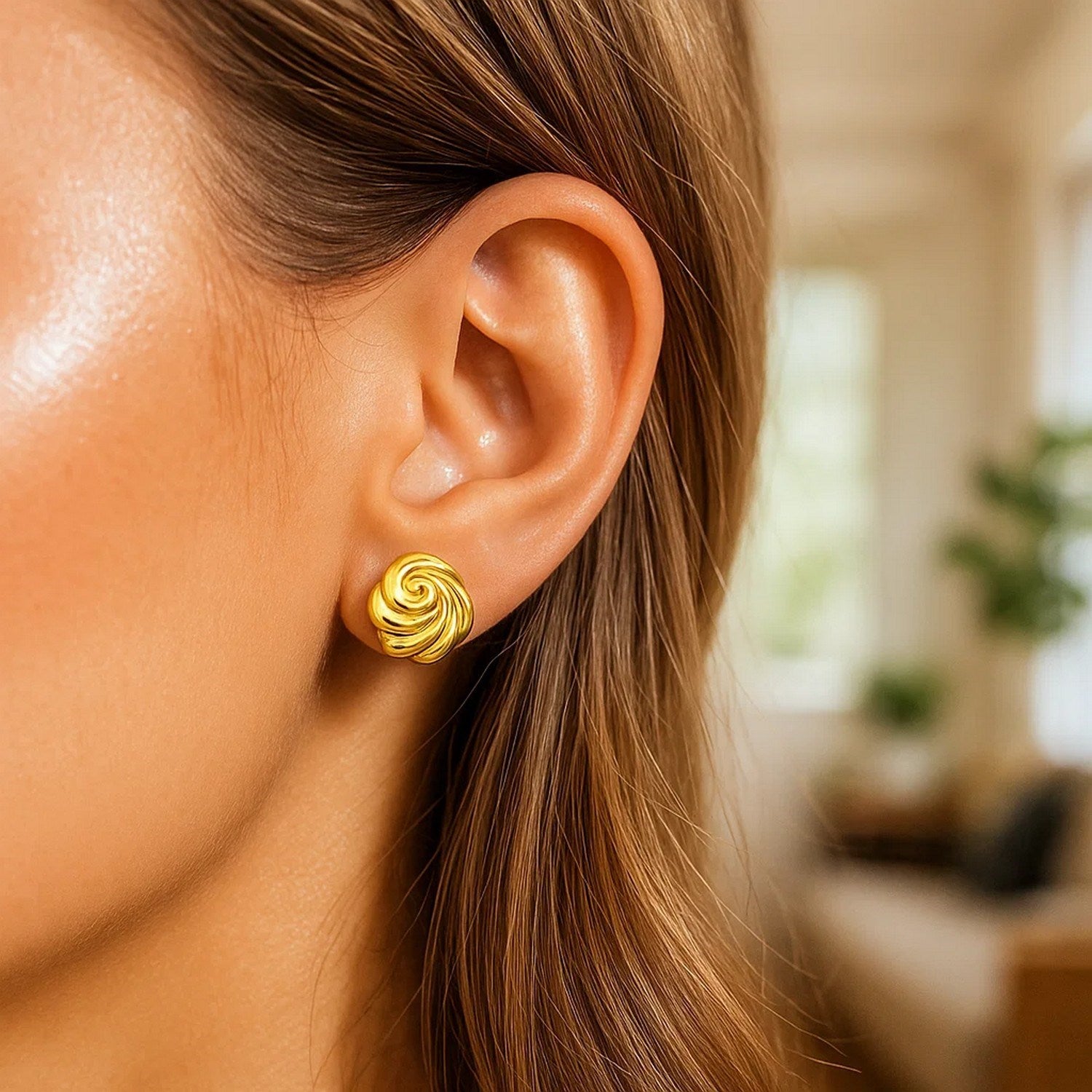 14k yellow gold modern swirl knot stud earrings with a sleek round design, perfect for elegant everyday wear.