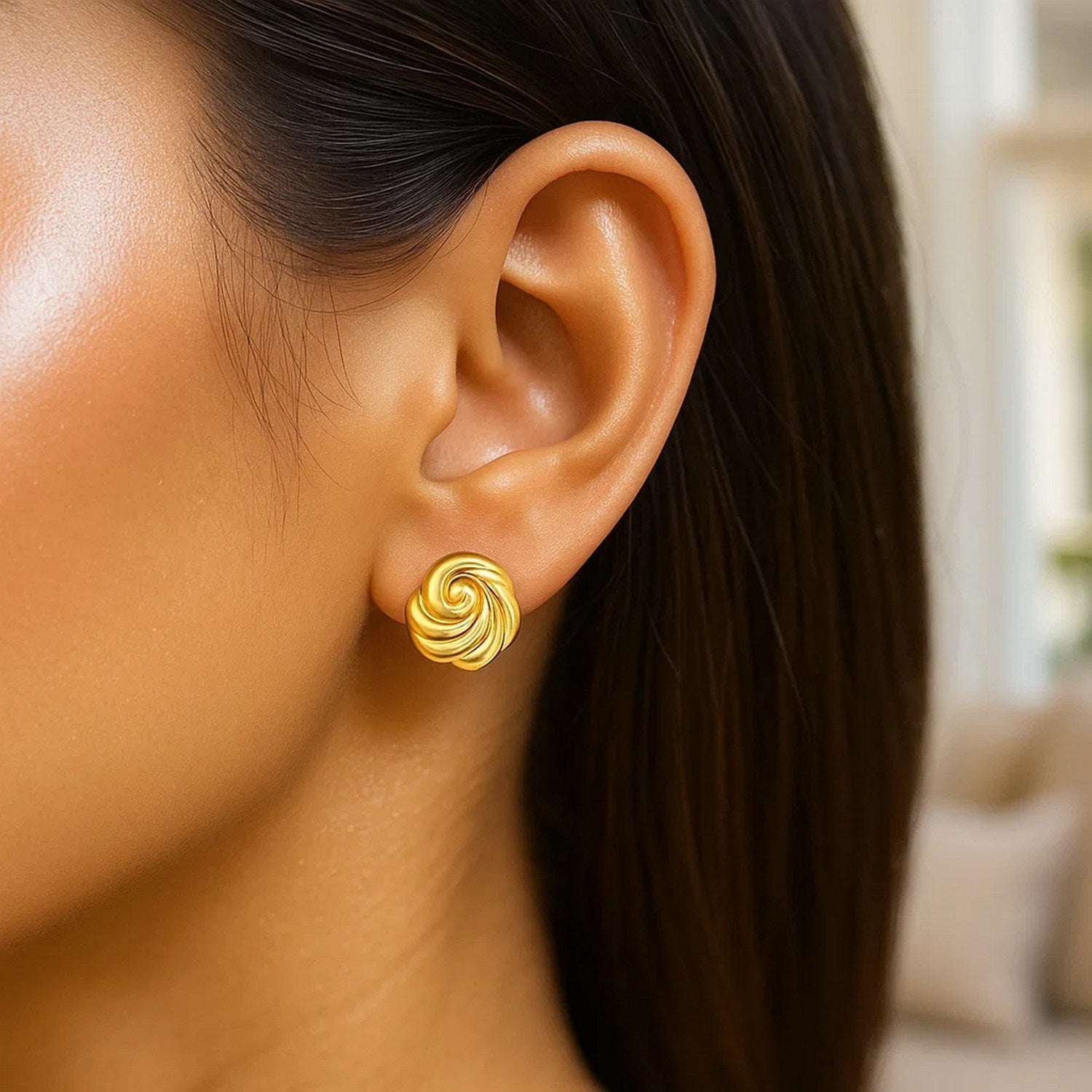 14k yellow gold modern swirl knot stud earrings with a polished finish, perfect for elegant everyday wear.