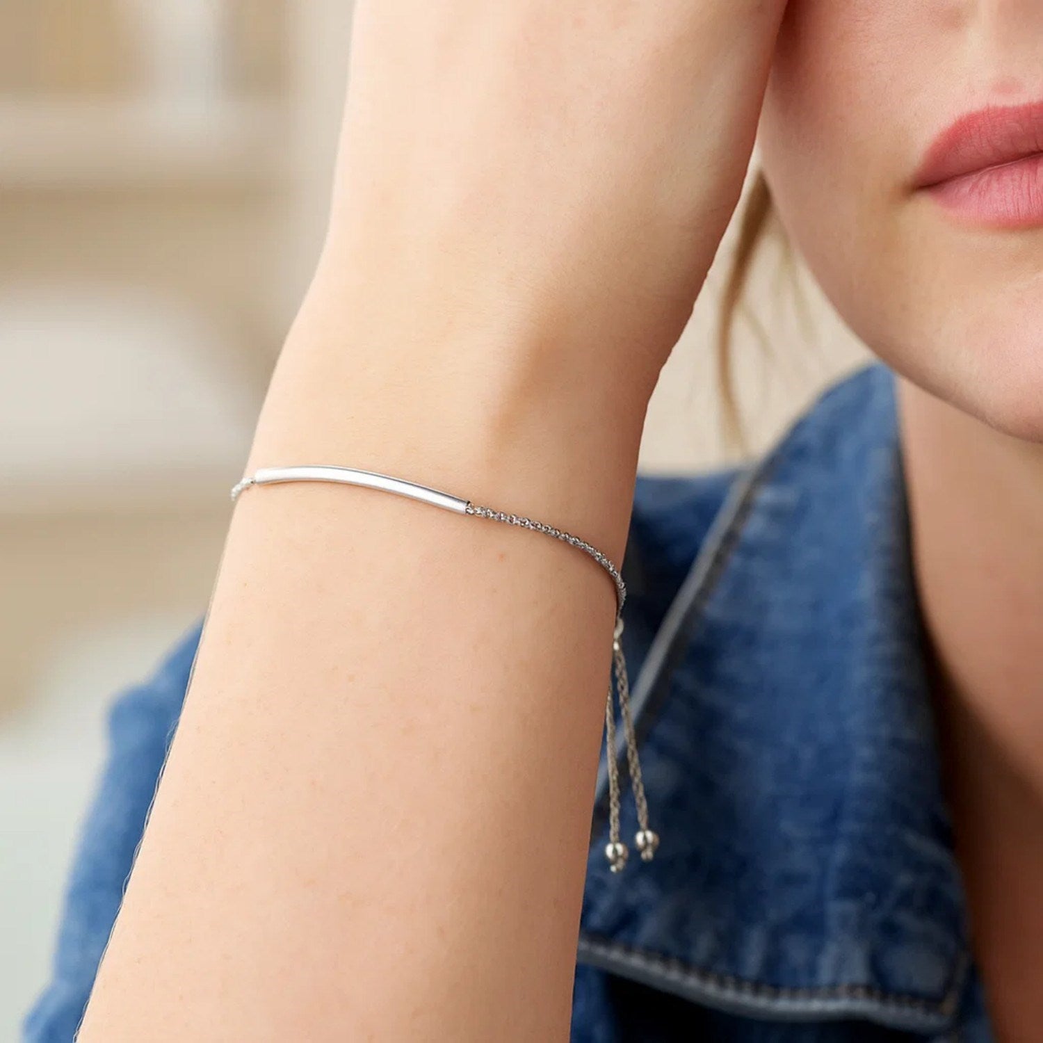 14k white gold minimalist lariat bracelet with smooth curved bar design and elegant chain detail.