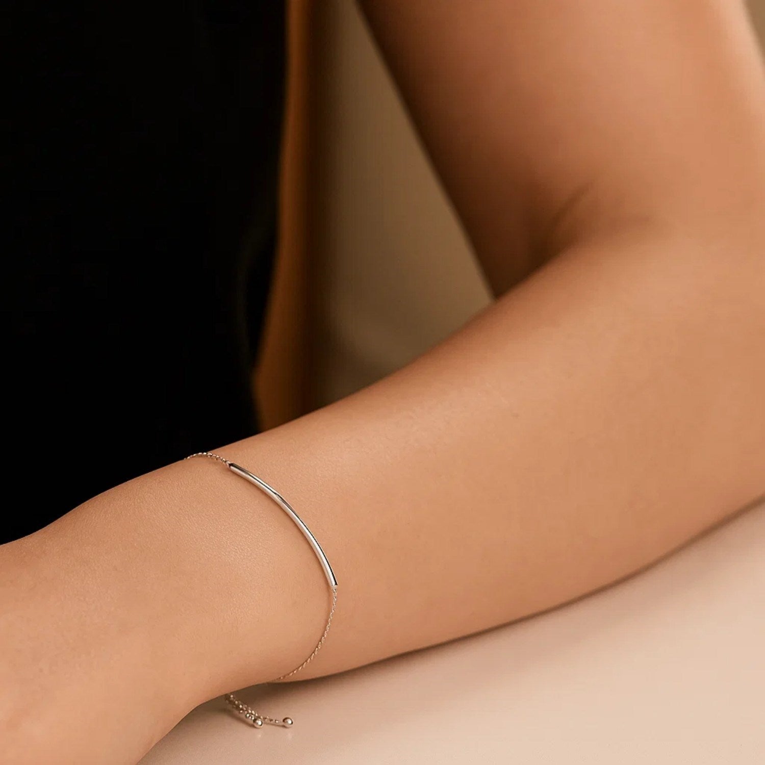 14k white gold minimalist curved bar lariat bracelet with sleek chain design, perfect for elegant layering.