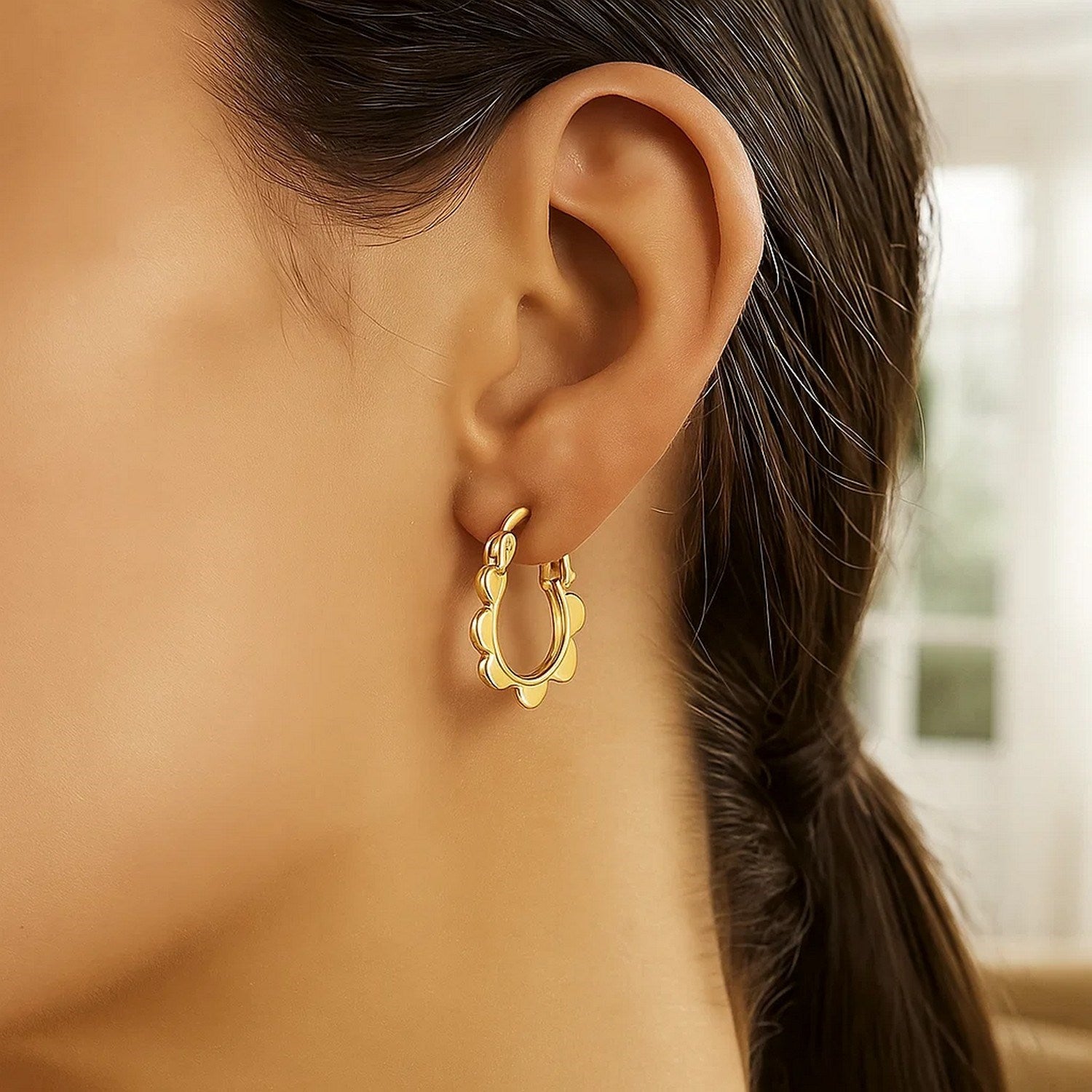 14k yellow gold scalloped hoop earrings showcasing a contemporary design with elegant curves and a polished finish.
