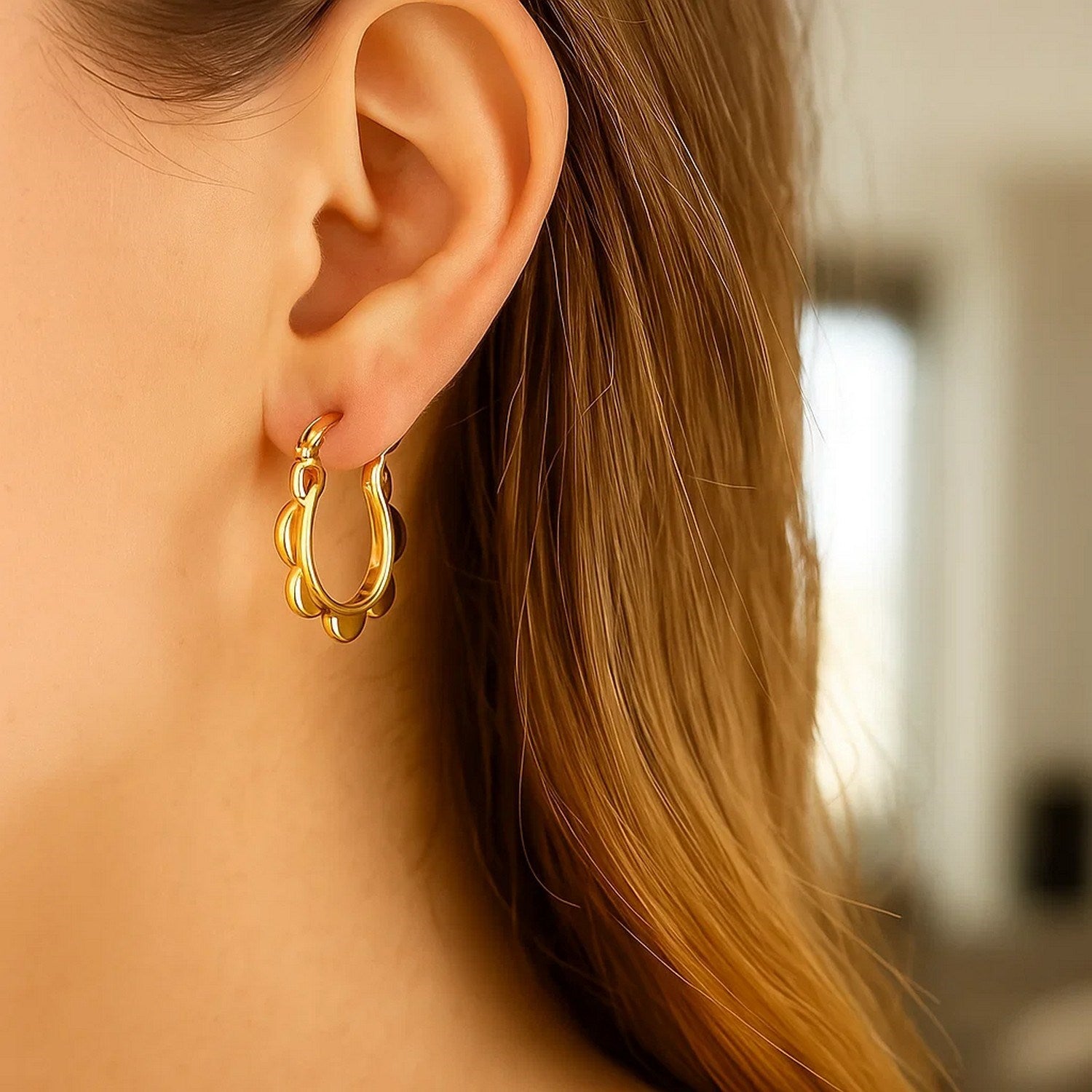 Contemporary 14k yellow gold scalloped hoop earrings showcasing a luxurious, elegant design for refined style.