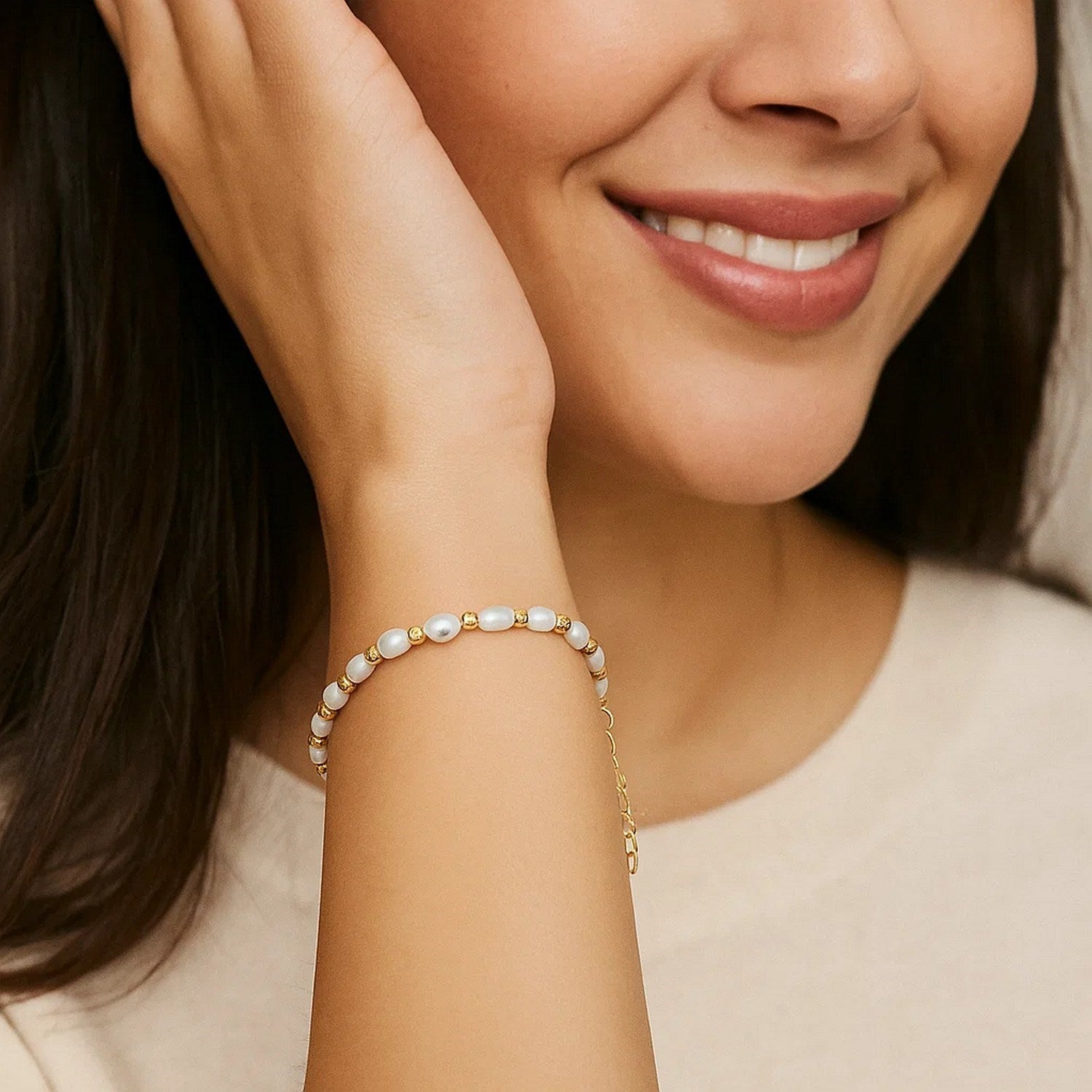 Elegant 14k yellow gold bracelet featuring faceted beads and lustrous freshwater pearls for a luxurious touch.