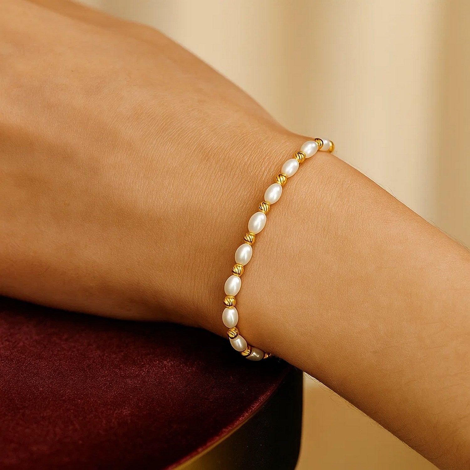 14K yellow gold faceted bead bracelet adorned with elegant freshwater pearls, showcasing timeless luxury and sophistication.