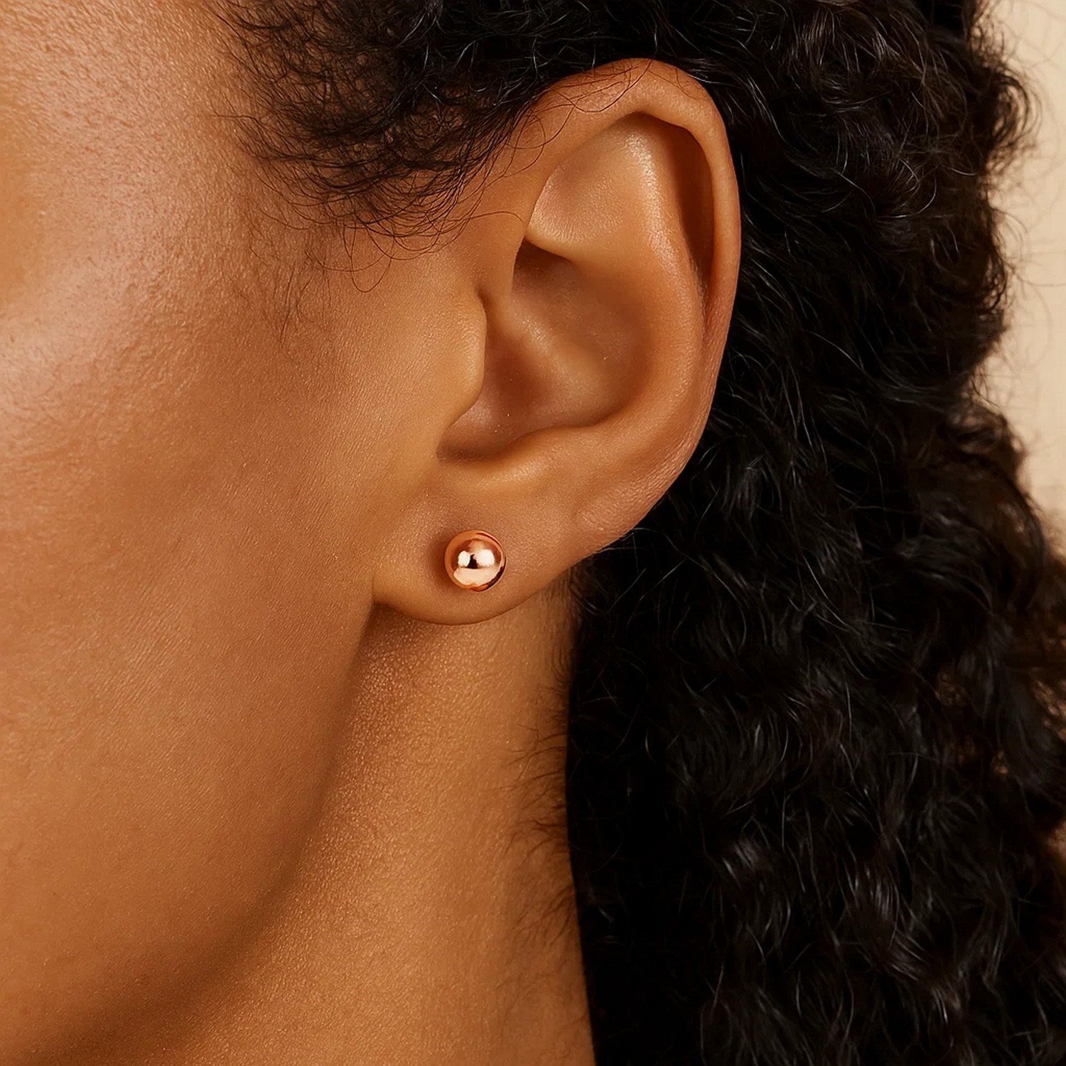 14k rose gold round stud earrings (5mm) with a modern design, perfect for elegant everyday wear.