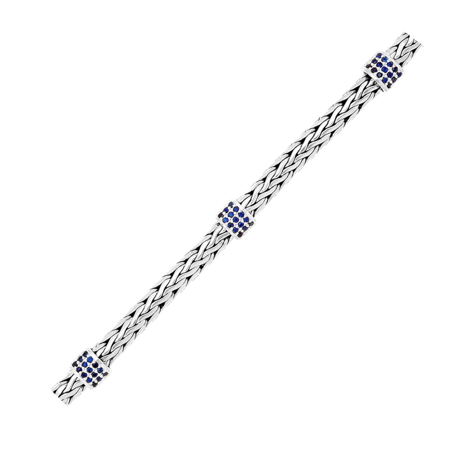 Sterling silver woven bracelet featuring exquisite blue sapphire stations in a modern luxury design.
