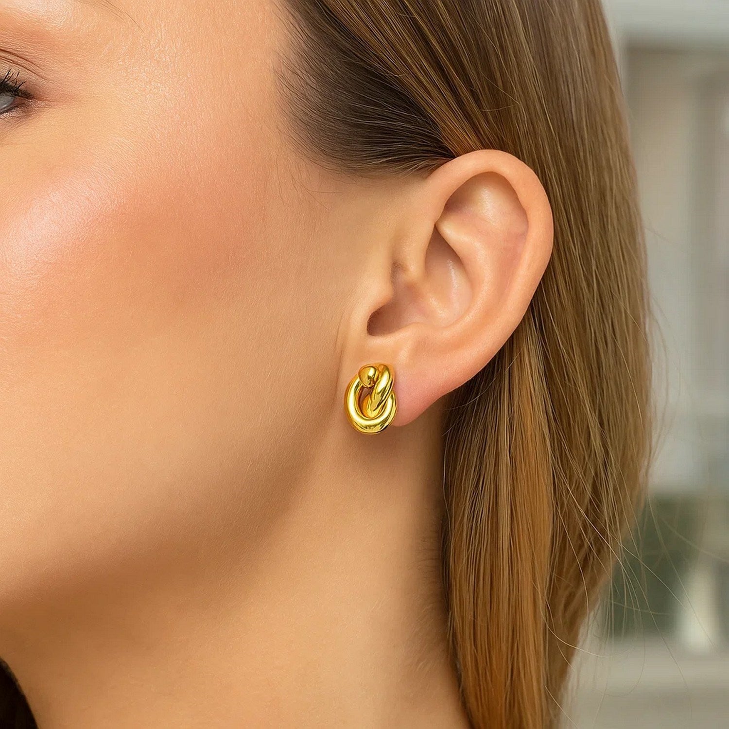 14k yellow gold polished knot stud earrings, showcasing a modern design with elegant simplicity and refined craftsmanship.