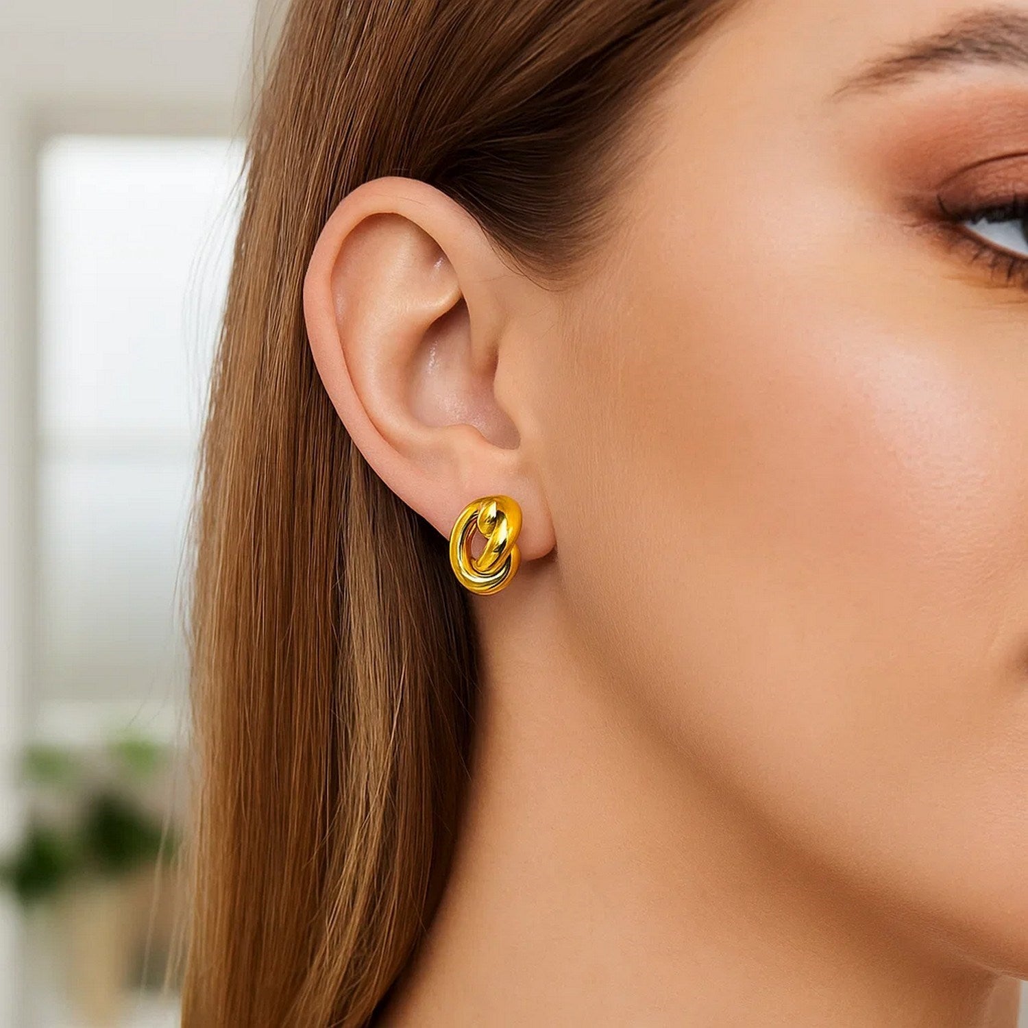 14k yellow gold polished knot stud earrings featuring a modern design for timeless elegance and sophistication.