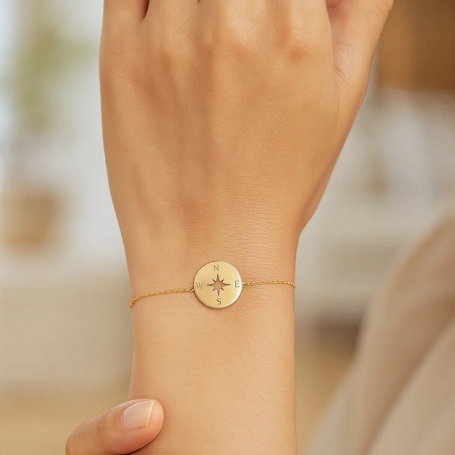 14k yellow gold 7-inch bracelet with elegant link design and compass charm, perfect for luxury accessory lovers.