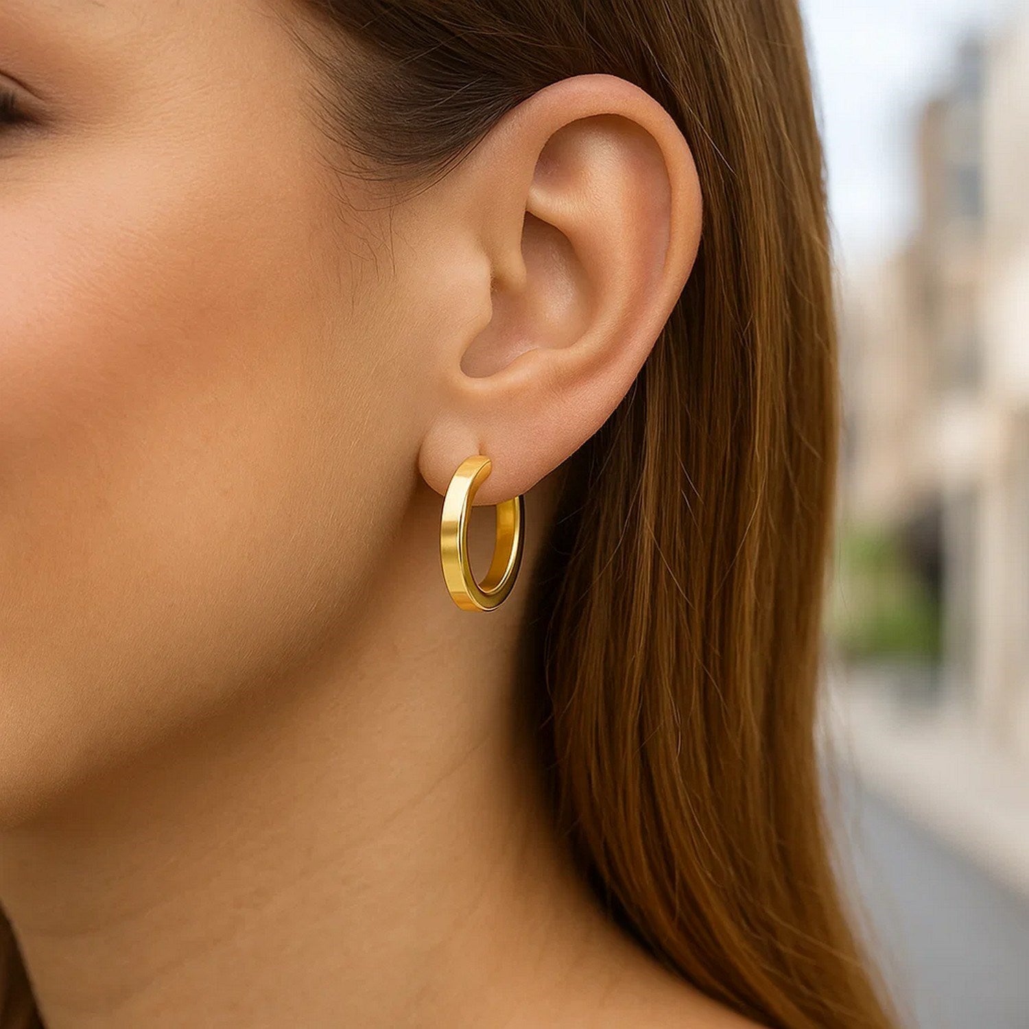 14K yellow gold polished hoop earrings with a modern design, perfect for elegant everyday wear.