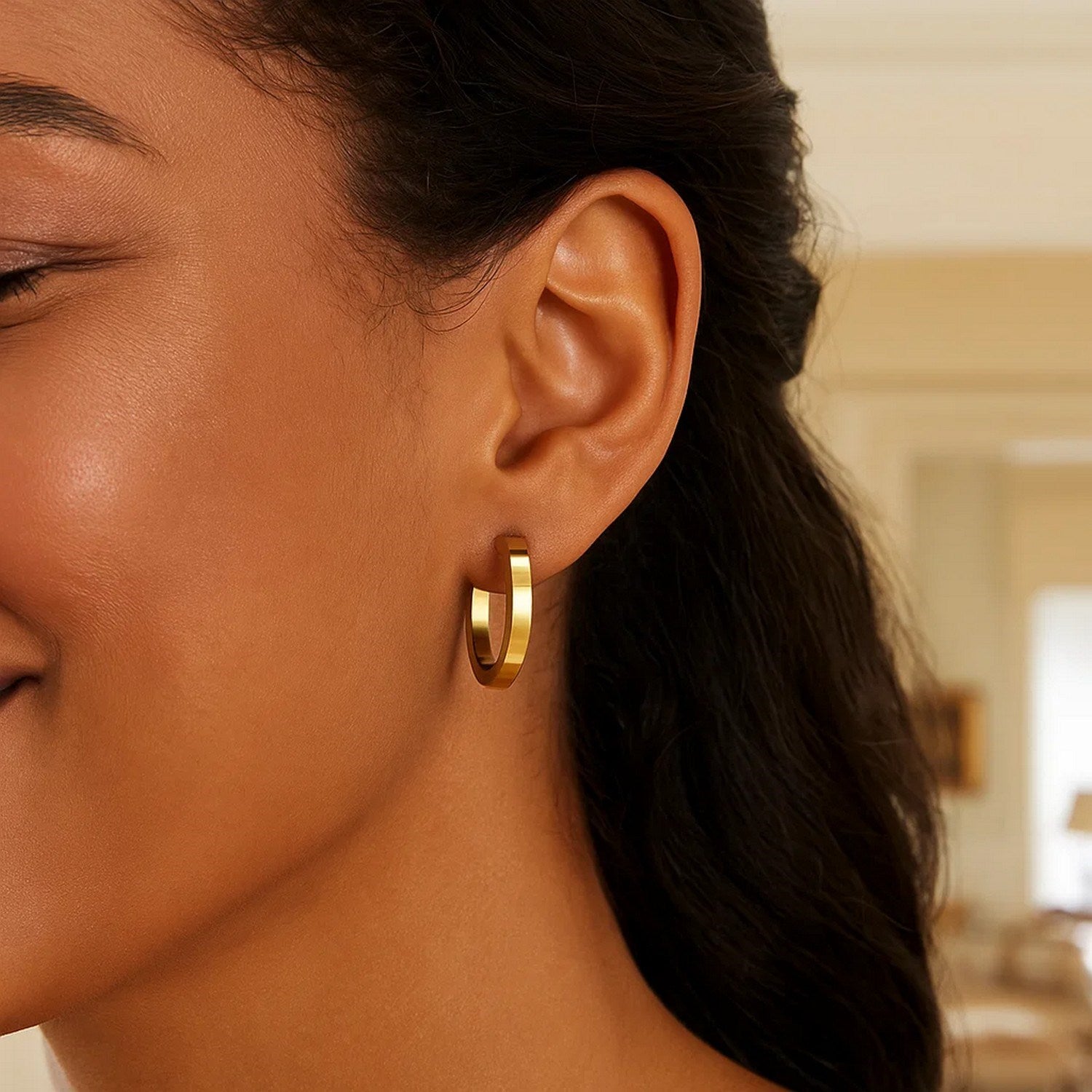 14K yellow gold polished hoop earrings with a modern design and secure stud closure, perfect for elegant occasions.