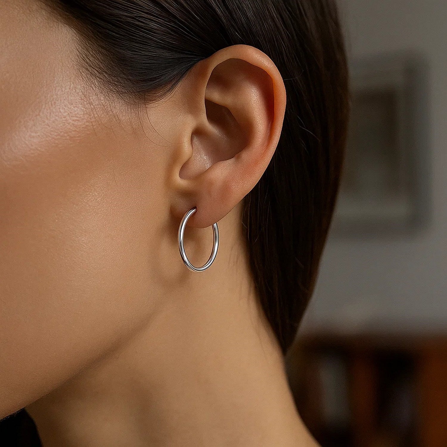 Sterling silver polished thin hoop earrings with rhodium plating, showcasing a modern and elegant design.