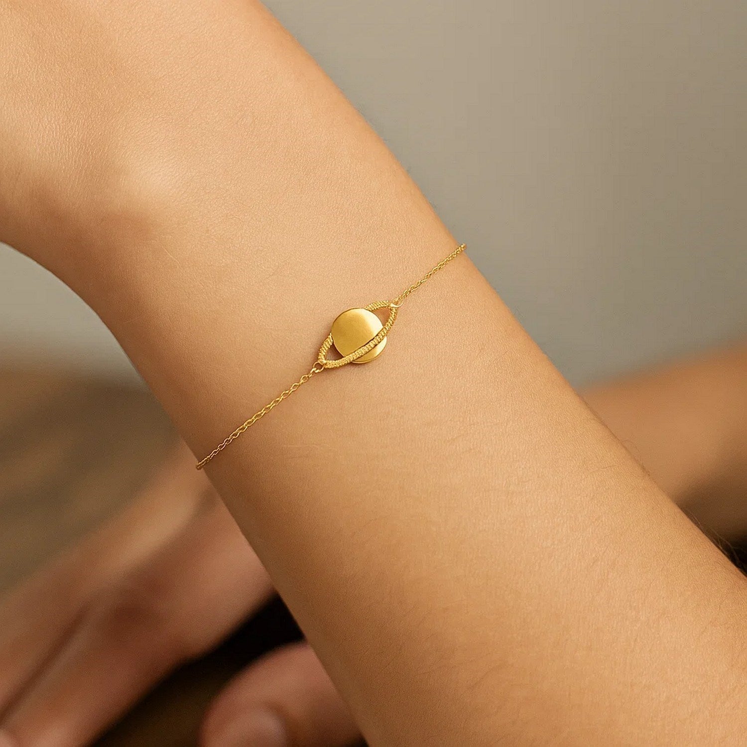 14k yellow gold modern Saturn bracelet featuring elegant chain link design for a luxurious touch.