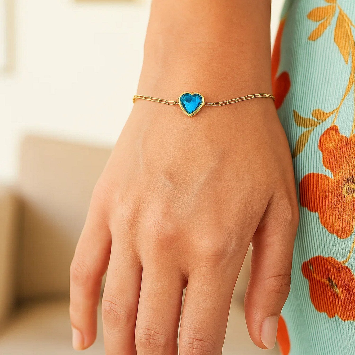 14k yellow gold bracelet featuring a heart-shaped blue topaz in a modern bezel setting, showcasing exquisite craftsmanship.