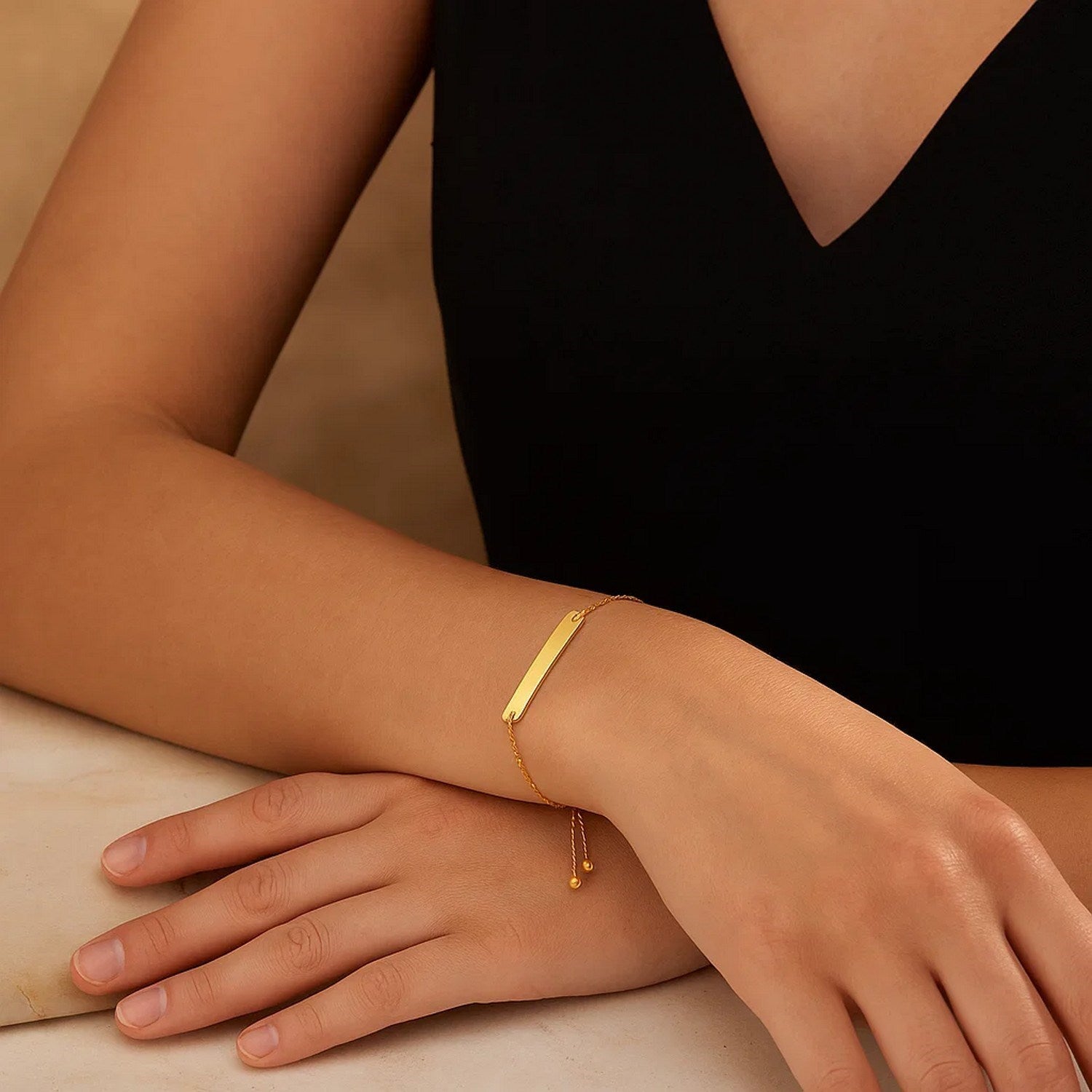 Adjustable 14k yellow gold bracelet featuring a sleek shiny bar design, embodying modern luxury elegance.