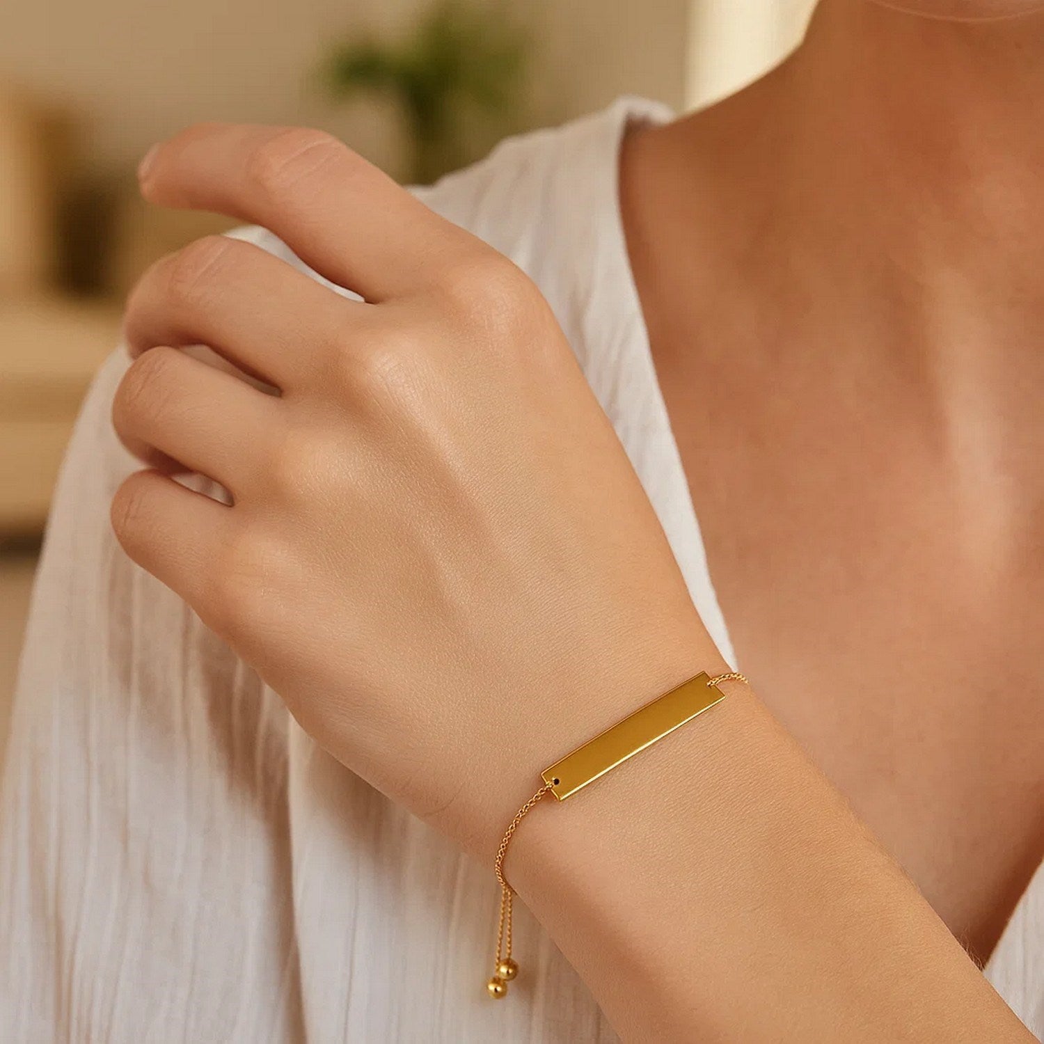 Adjustable 14k yellow gold bracelet featuring a sleek shiny bar, embodying modern luxury elegance.