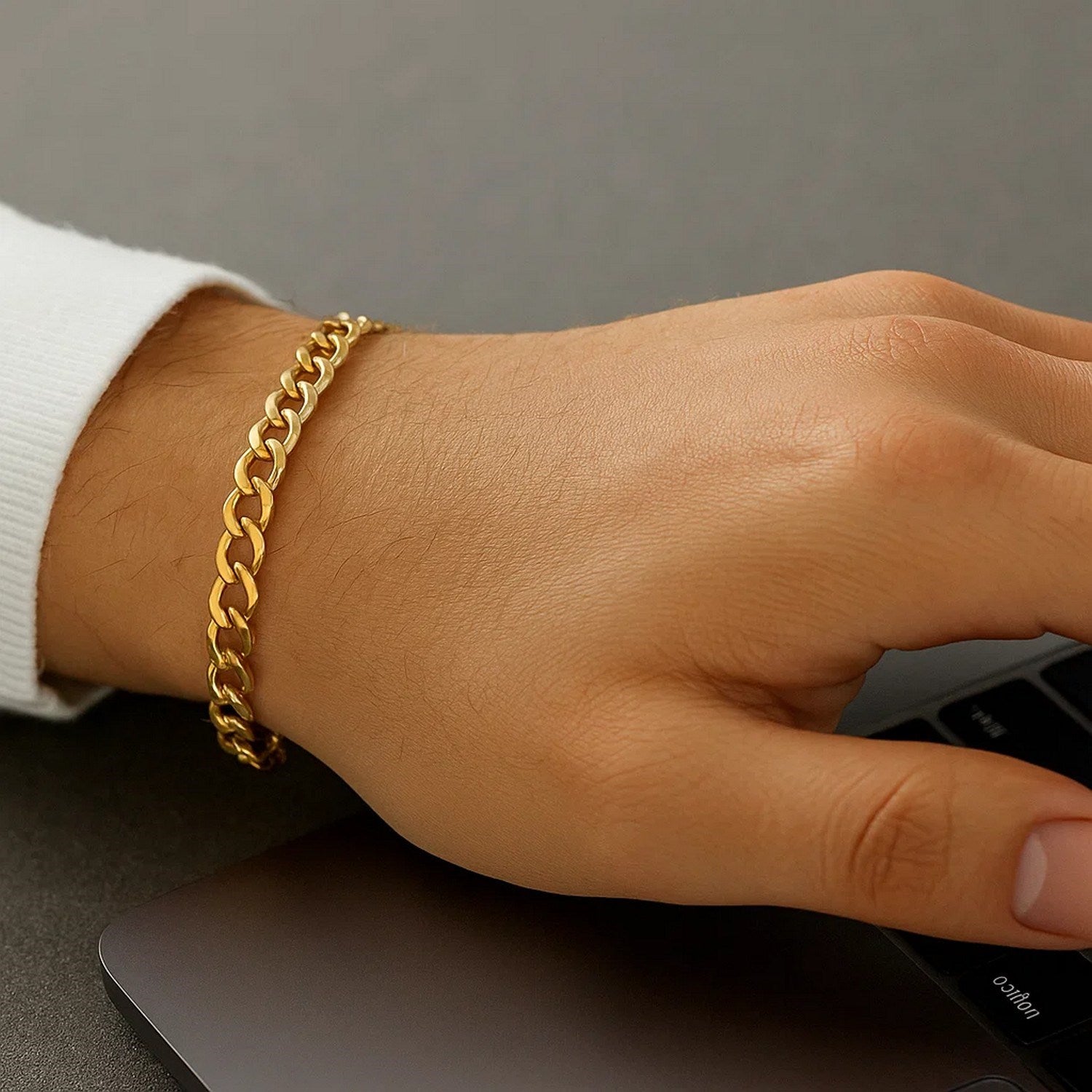 14k yellow gold minimalist curb bracelet featuring a sleek chain design, perfect for elegant layering or solo wear.