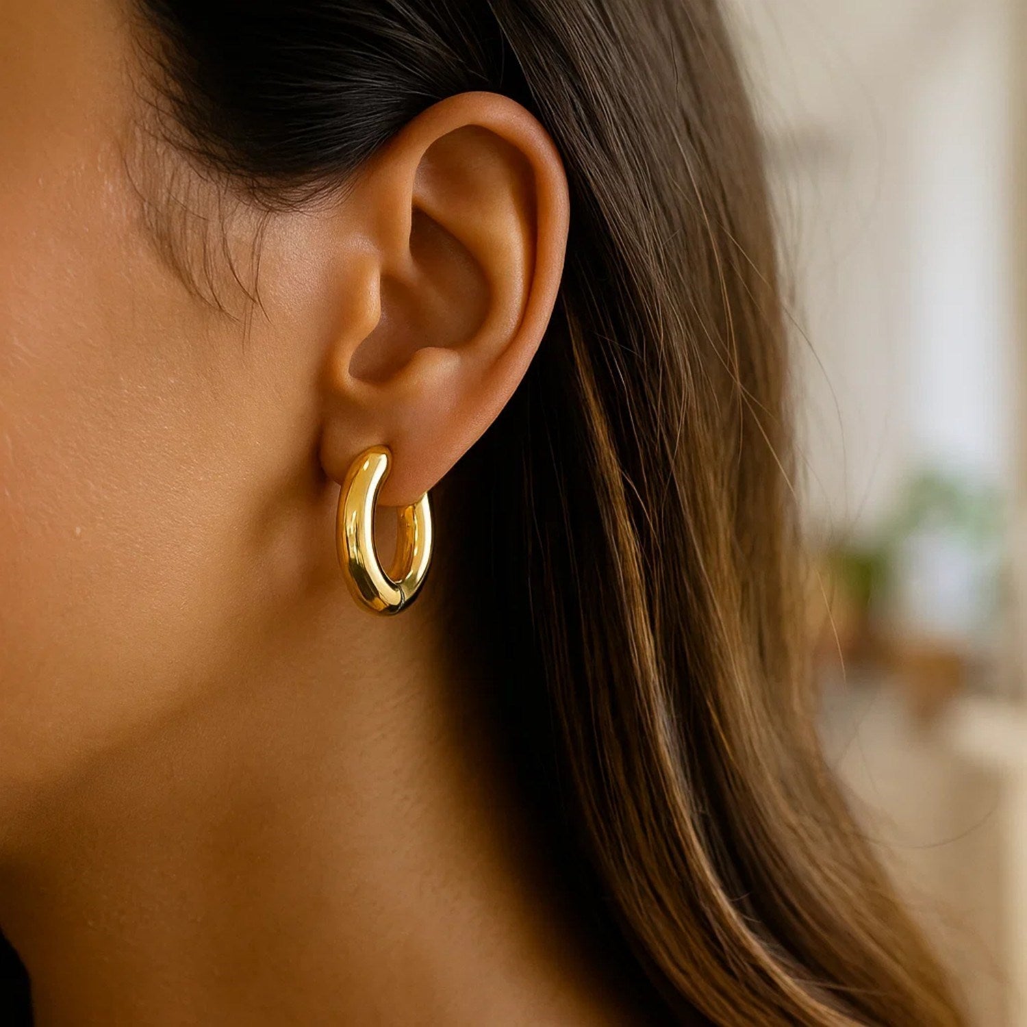 14K yellow gold polished hoop earrings with a sleek modern design, perfect for elegant everyday wear.