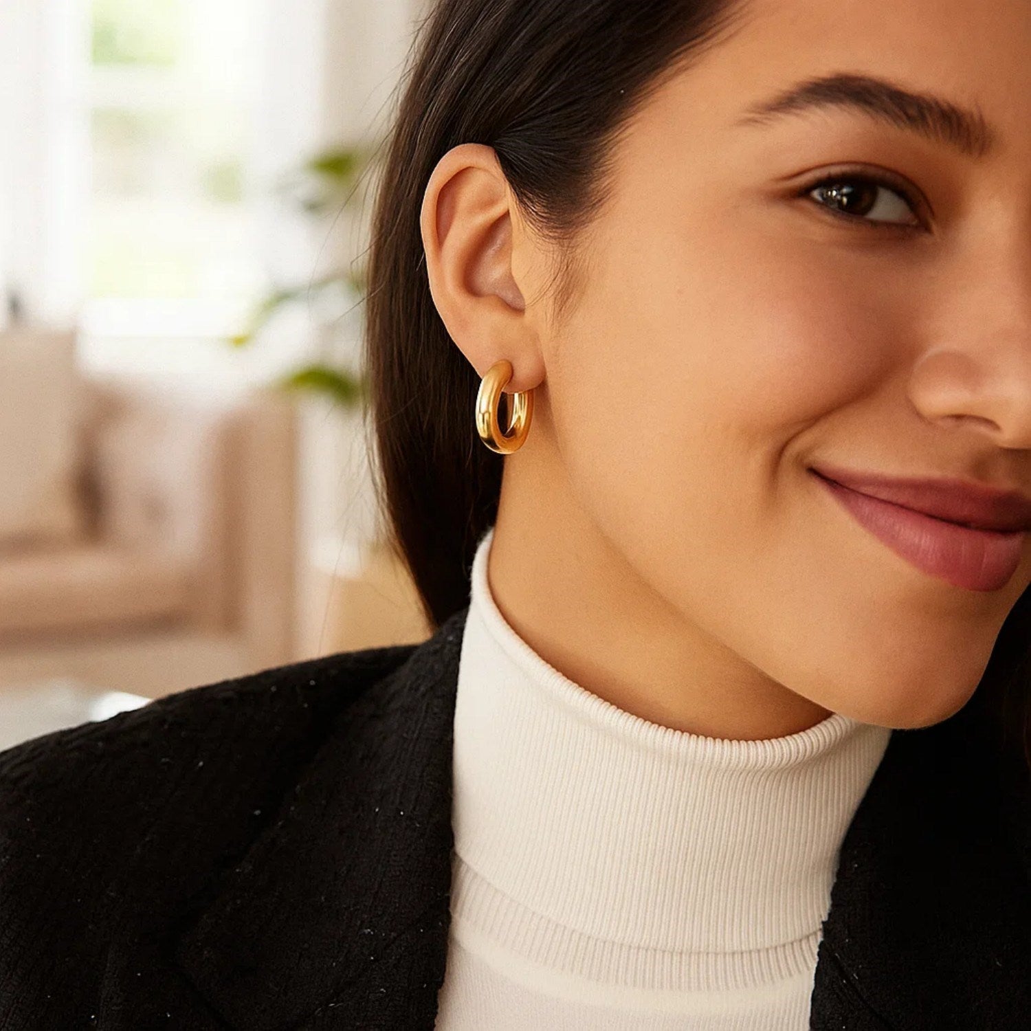 14K yellow gold polished hoop earrings with a modern design, showcasing a sleek and elegant round silhouette.