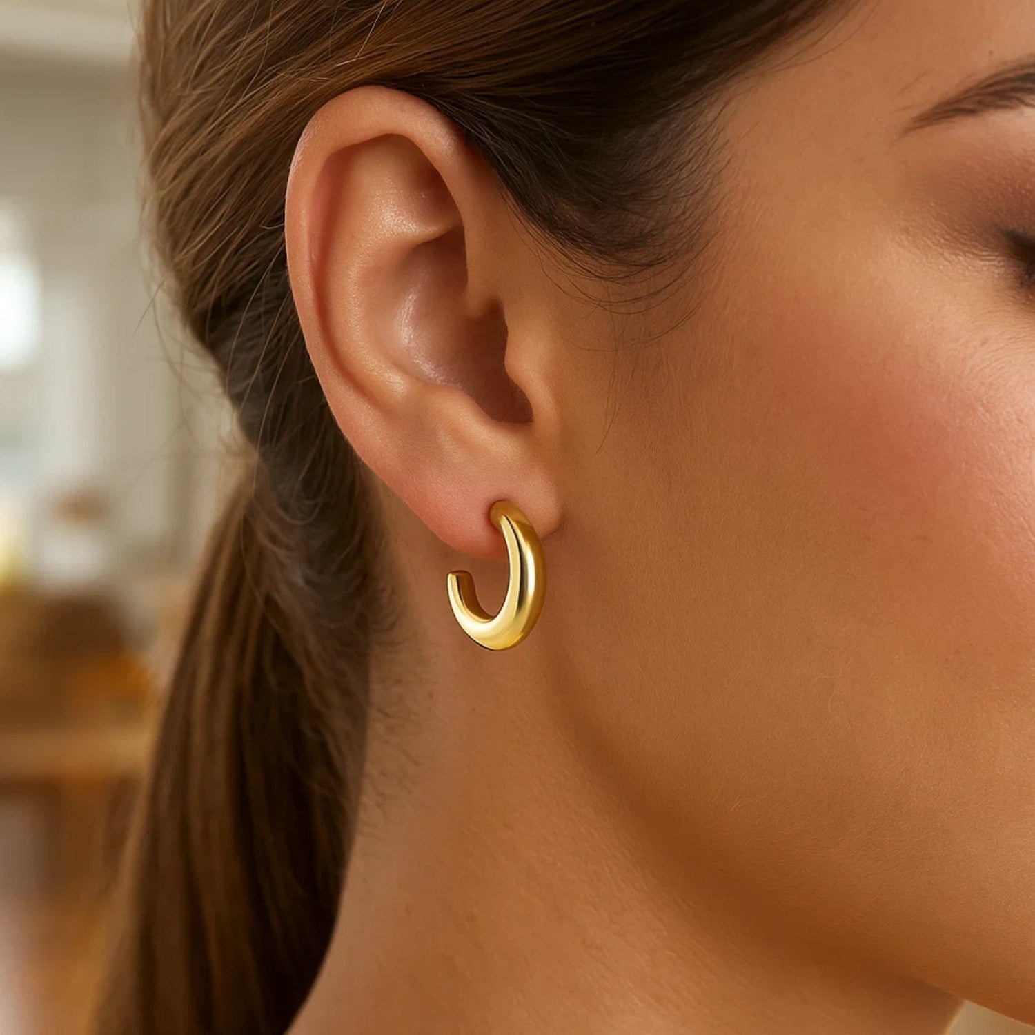 14k yellow gold polished hoop earrings with a sleek modern design, perfect for elegant everyday wear.