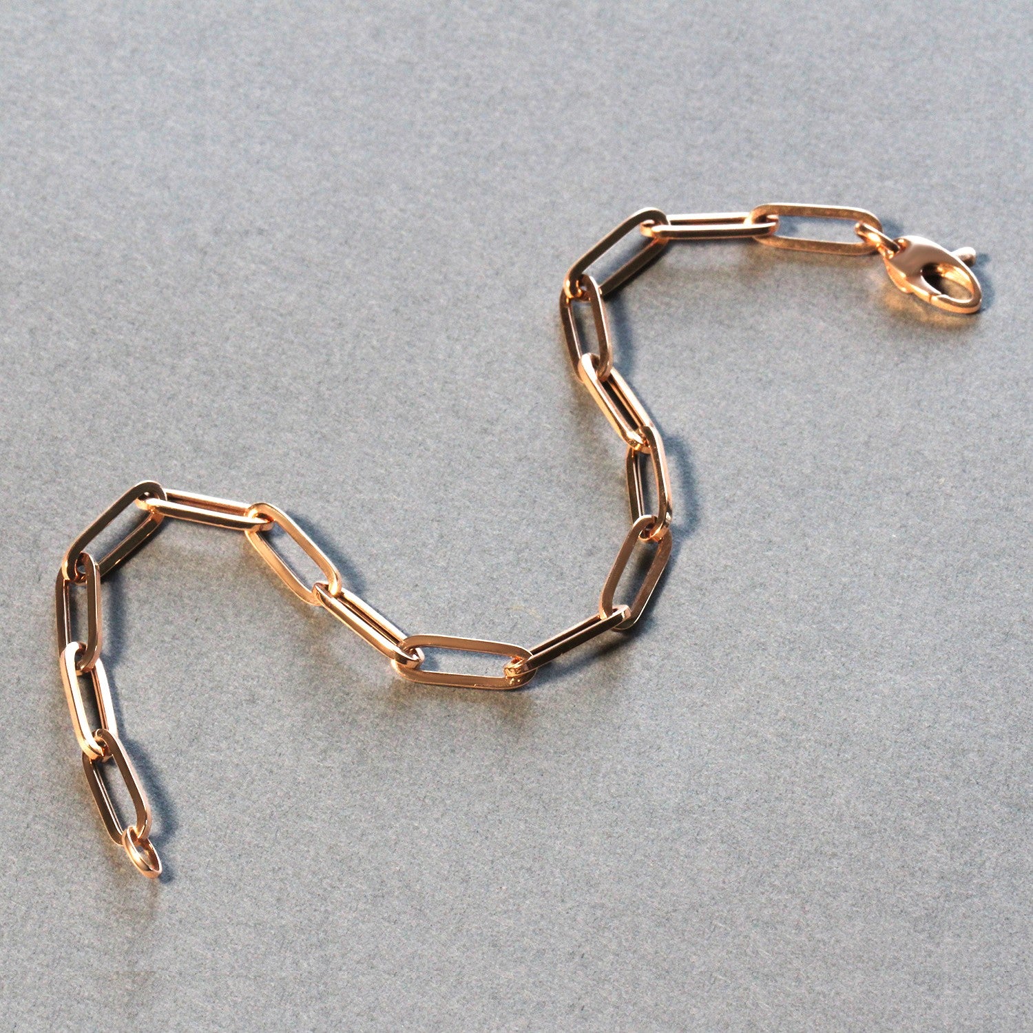 14K rose gold bold paperclip chain bracelet featuring modern links, perfect for elegant layering or standalone wear.