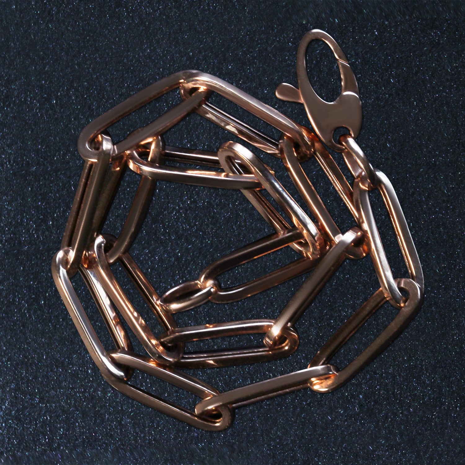 14k rose gold bold paperclip chain bracelet featuring modern links, perfect for elegant layering or standalone wear.