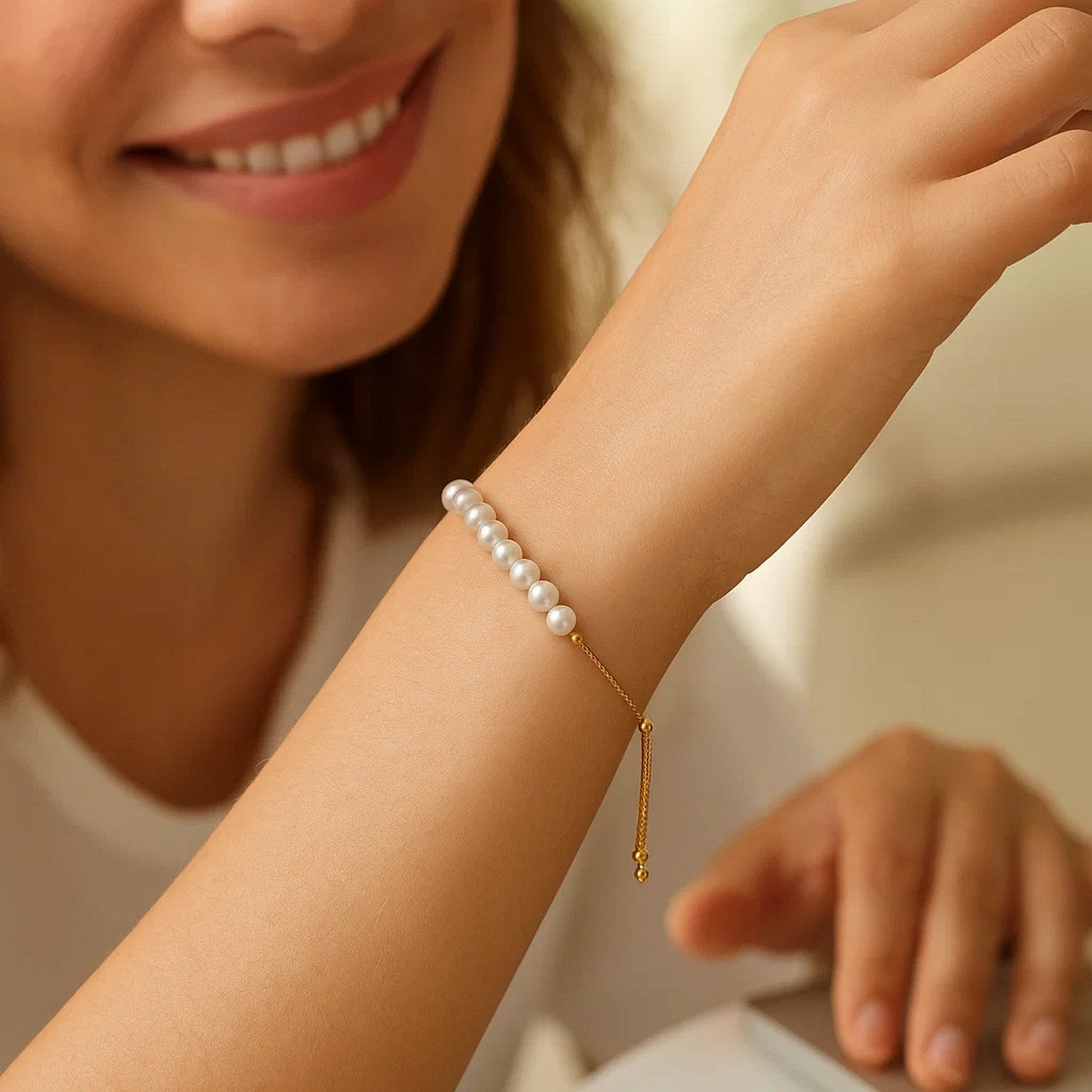 14k yellow gold adjustable friendship bracelet adorned with lustrous pearls in a modern round design.