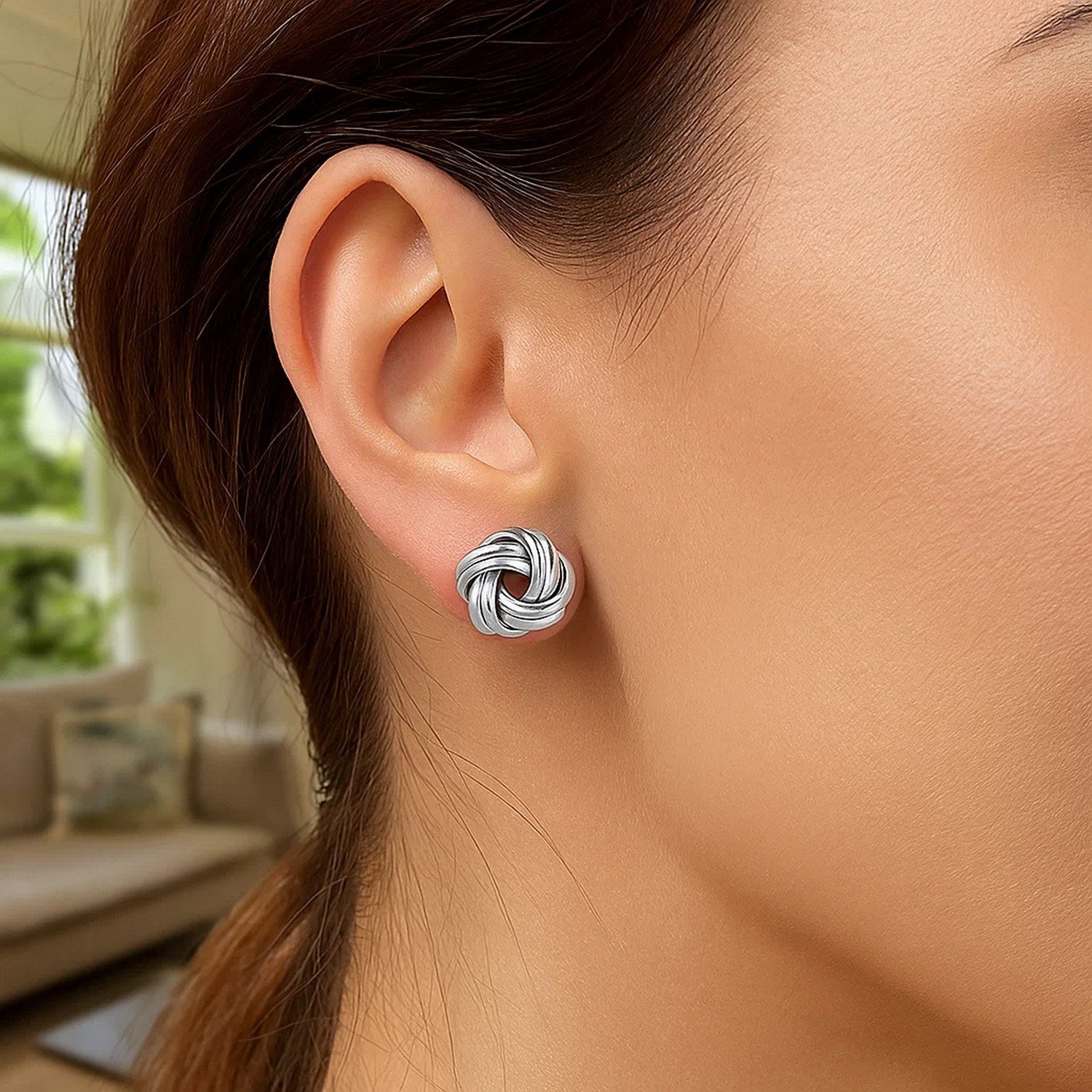 Sterling silver polished two strand love knot earrings, showcasing a modern design with luxurious elegance.