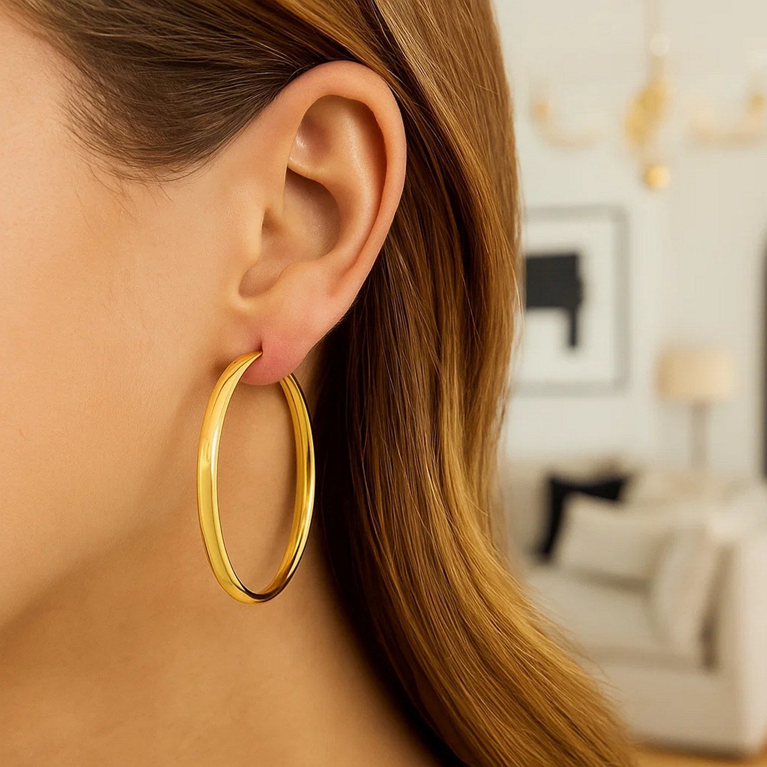 14k yellow gold polished hoop earrings with a sleek modern design, perfect for elegant everyday wear.
