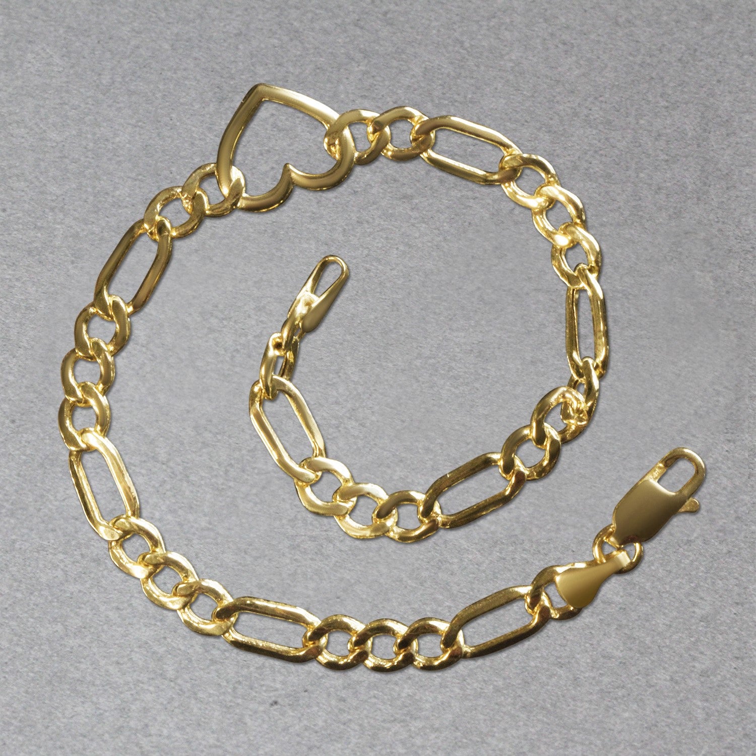 14k yellow gold Figaro chain bracelet with heart detail, contemporary design, 7 inches, 4.50 mm links.