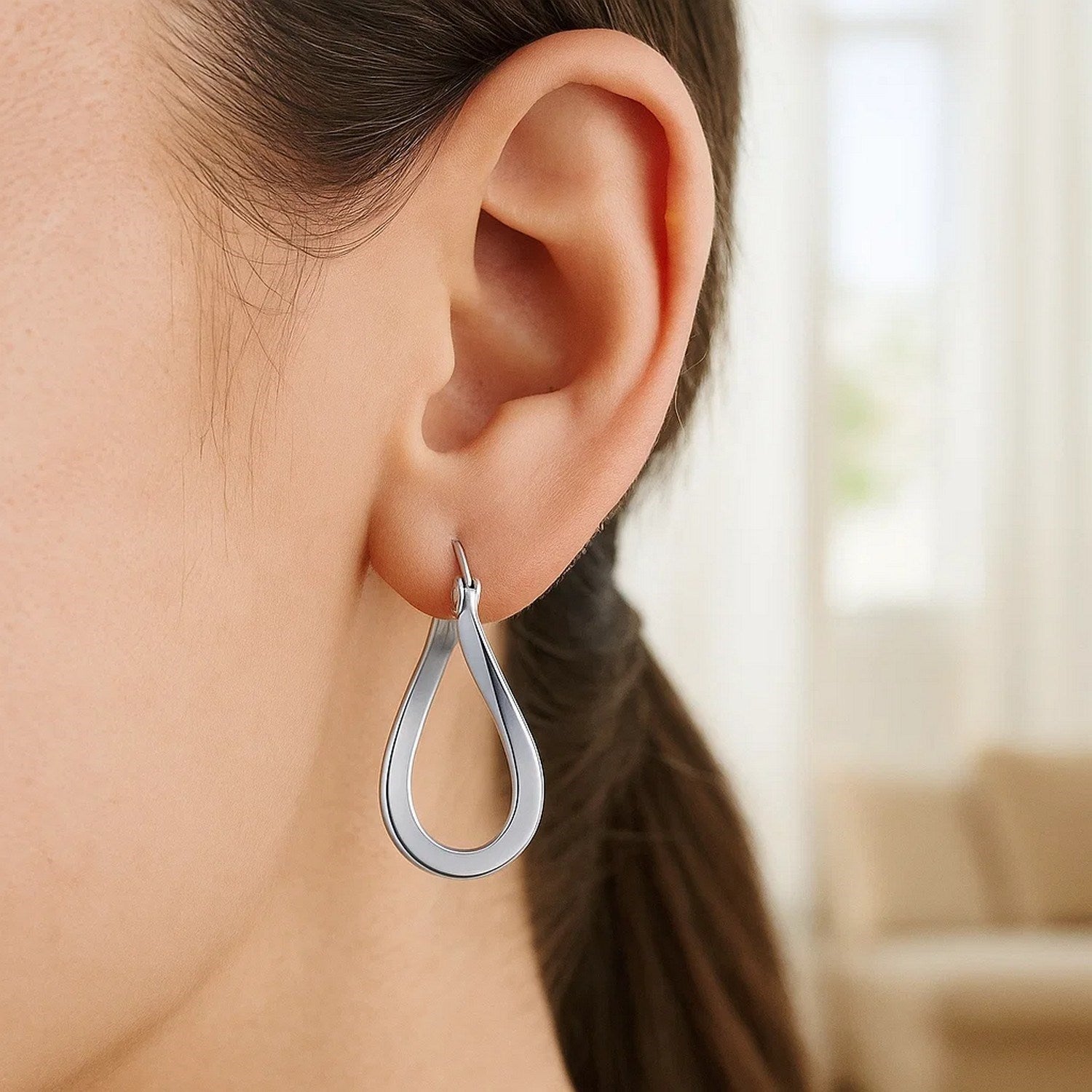 14k white gold polished twisted freeform hoop earrings, showcasing a modern design with elegant curves and shine.