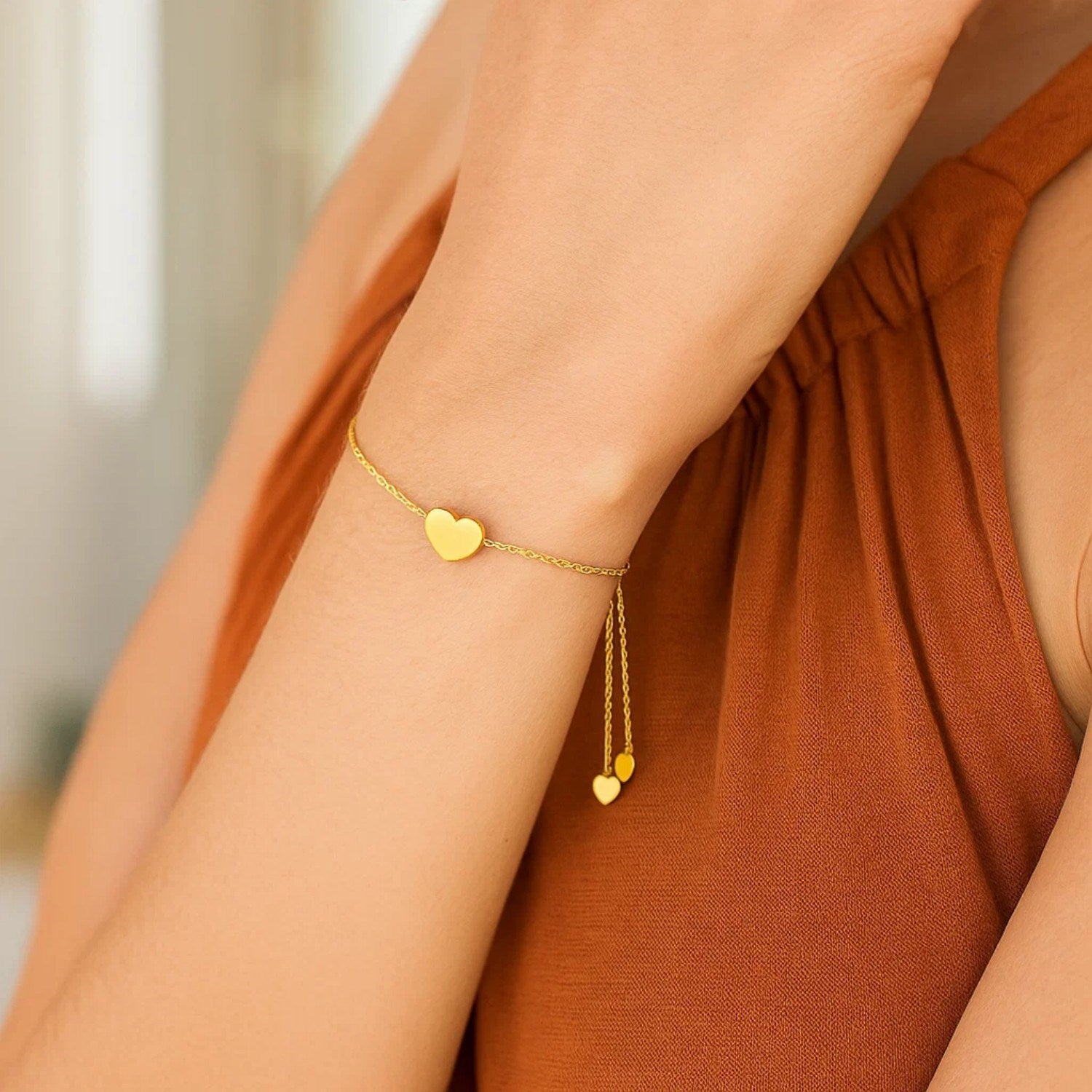 14k yellow gold adjustable heart bracelet featuring a modern chain design, perfect for elegant layering or solo wear.