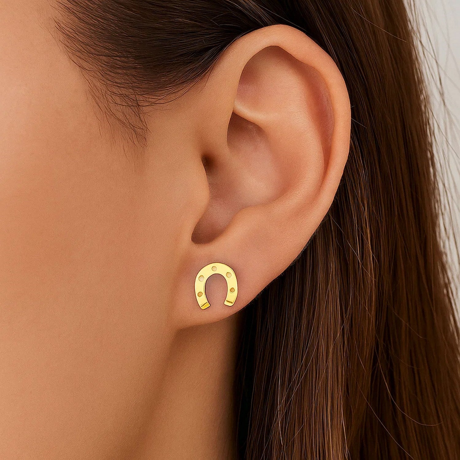 14k yellow gold textured horseshoe stud earrings with a modern design, perfect for elegant occasions.