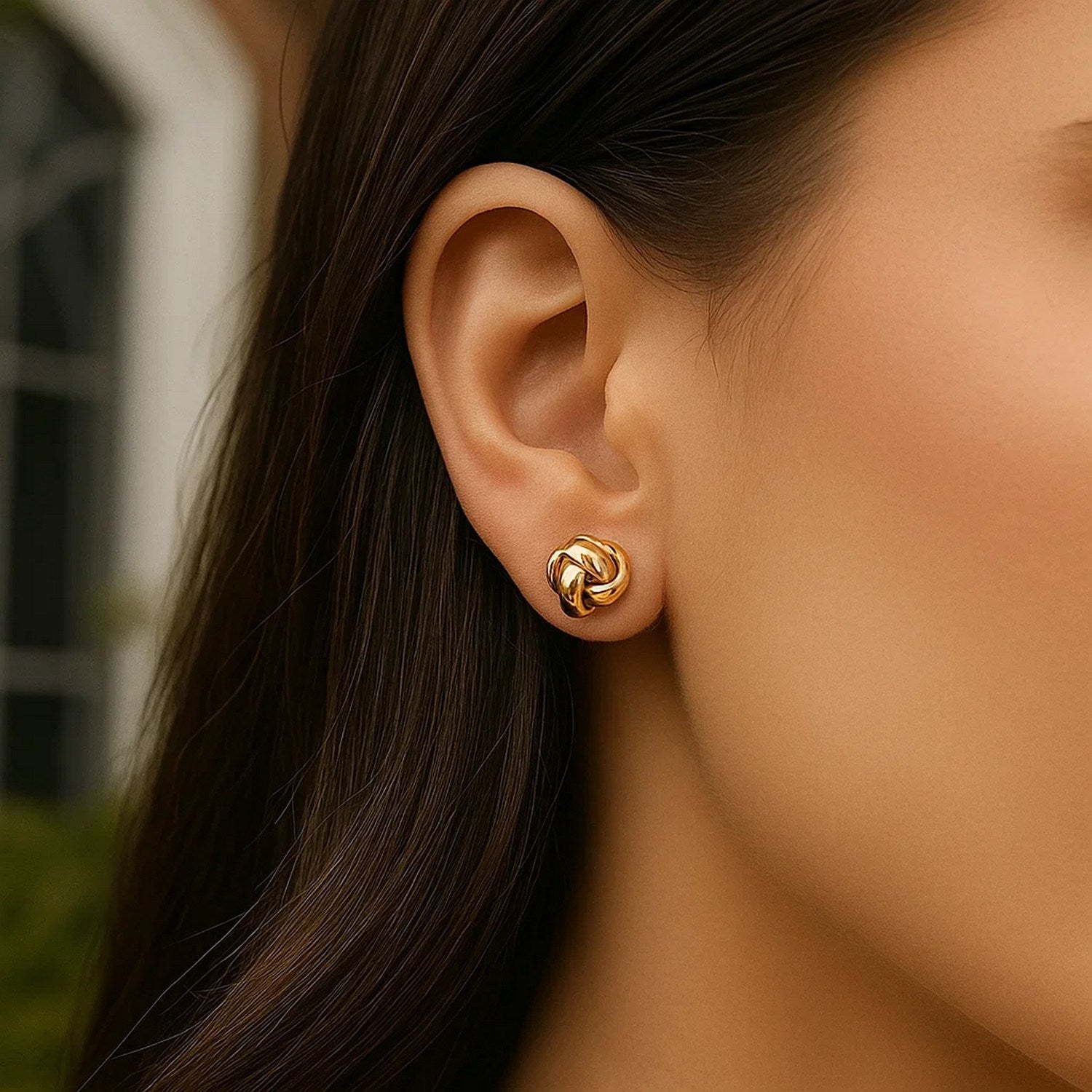14k yellow gold polished love knot stud earrings with a contemporary design, perfect for elegant everyday wear.