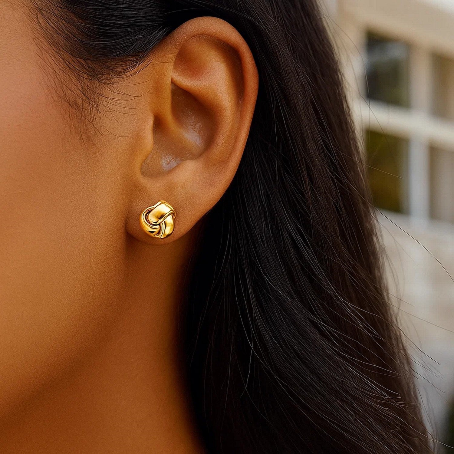14k yellow gold polished love knot stud earrings with a contemporary design, perfect for elegant occasions.
