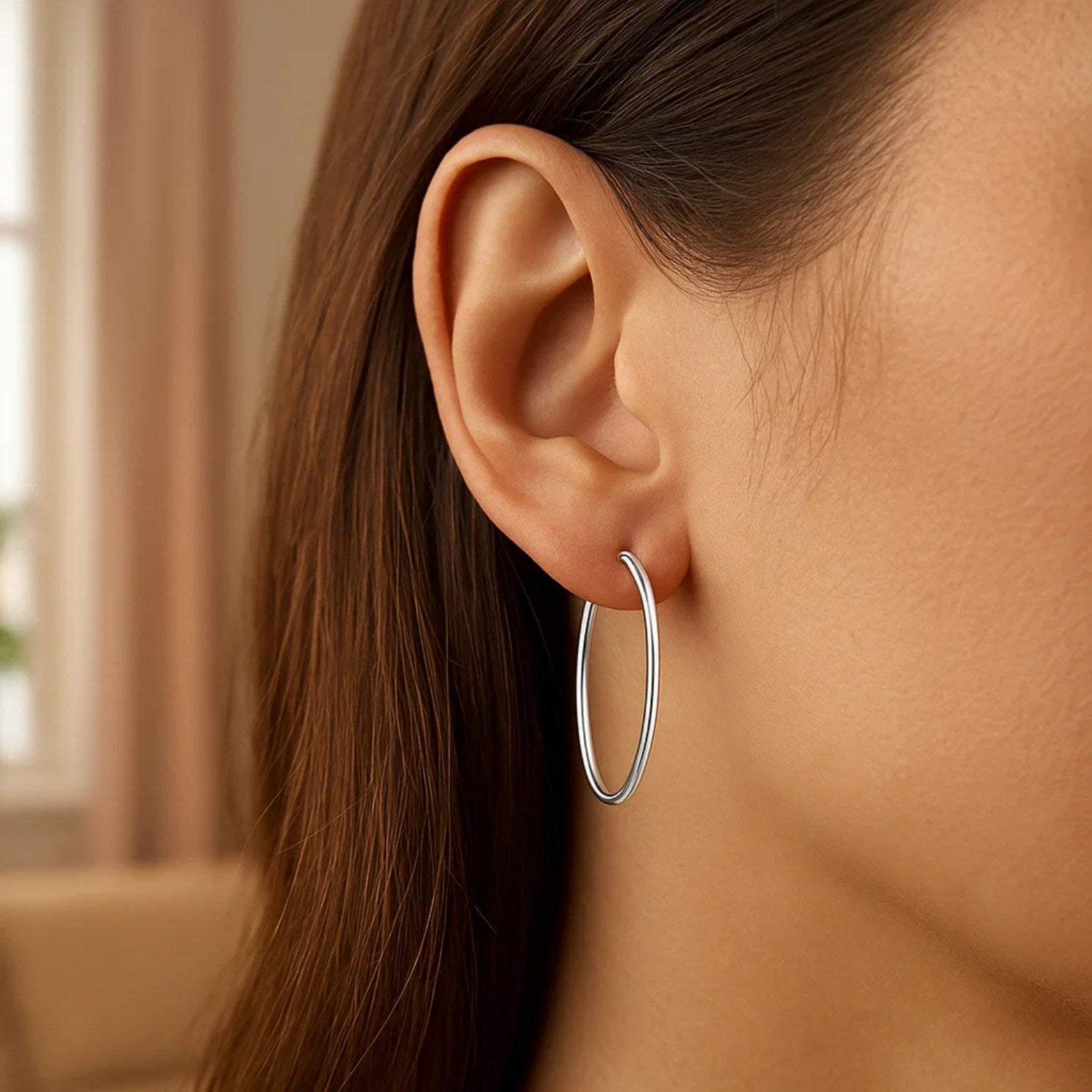 Polished 14k white gold hoop earrings showcasing a classic design and elegant shine, perfect for any occasion.
