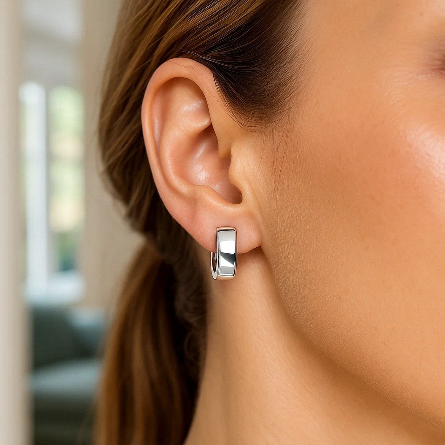 Elegant 14k white gold snuggable hoop earrings showcasing a polished finish and timeless design.