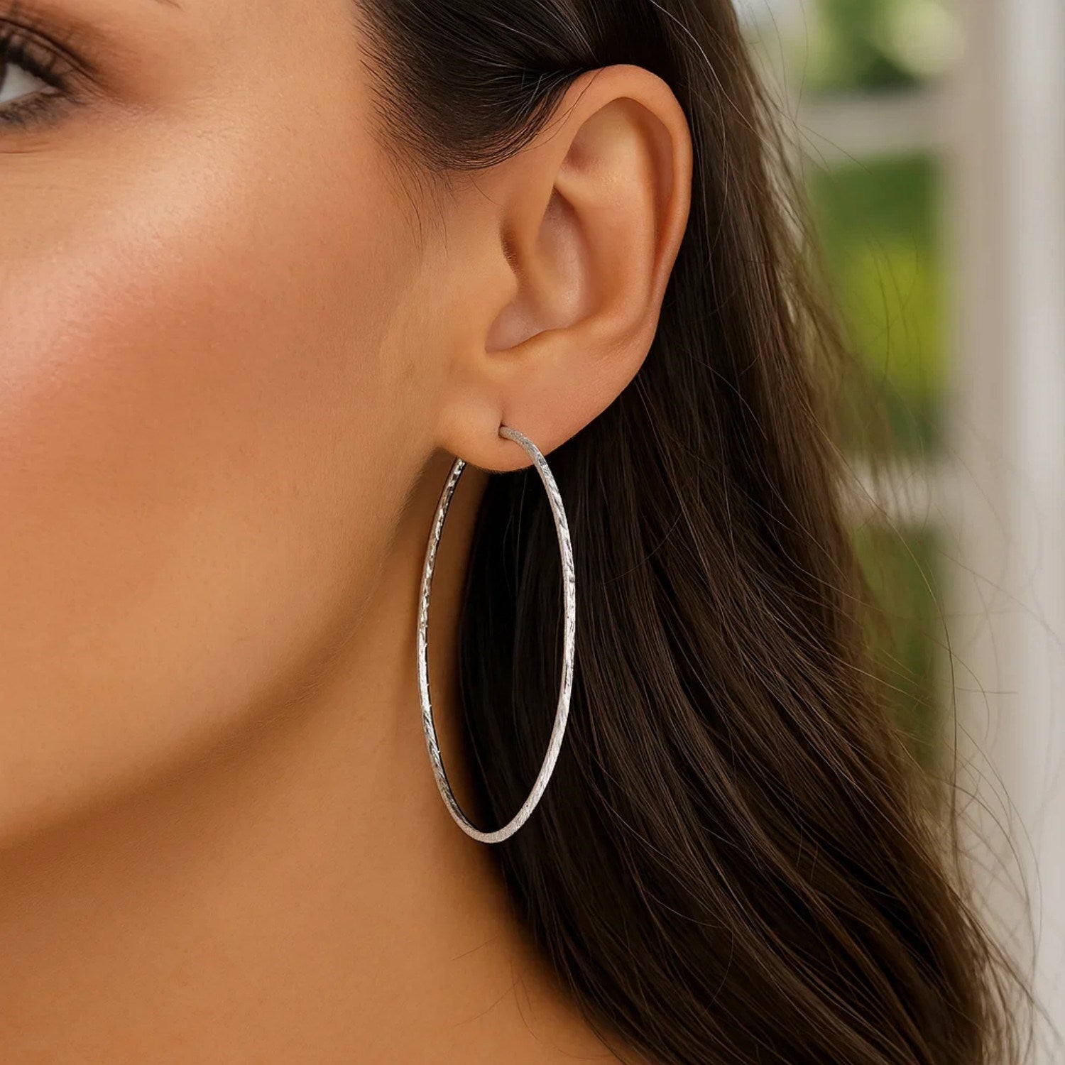 Sterling silver textured large round hoop earrings showcasing modern elegance and refined craftsmanship.