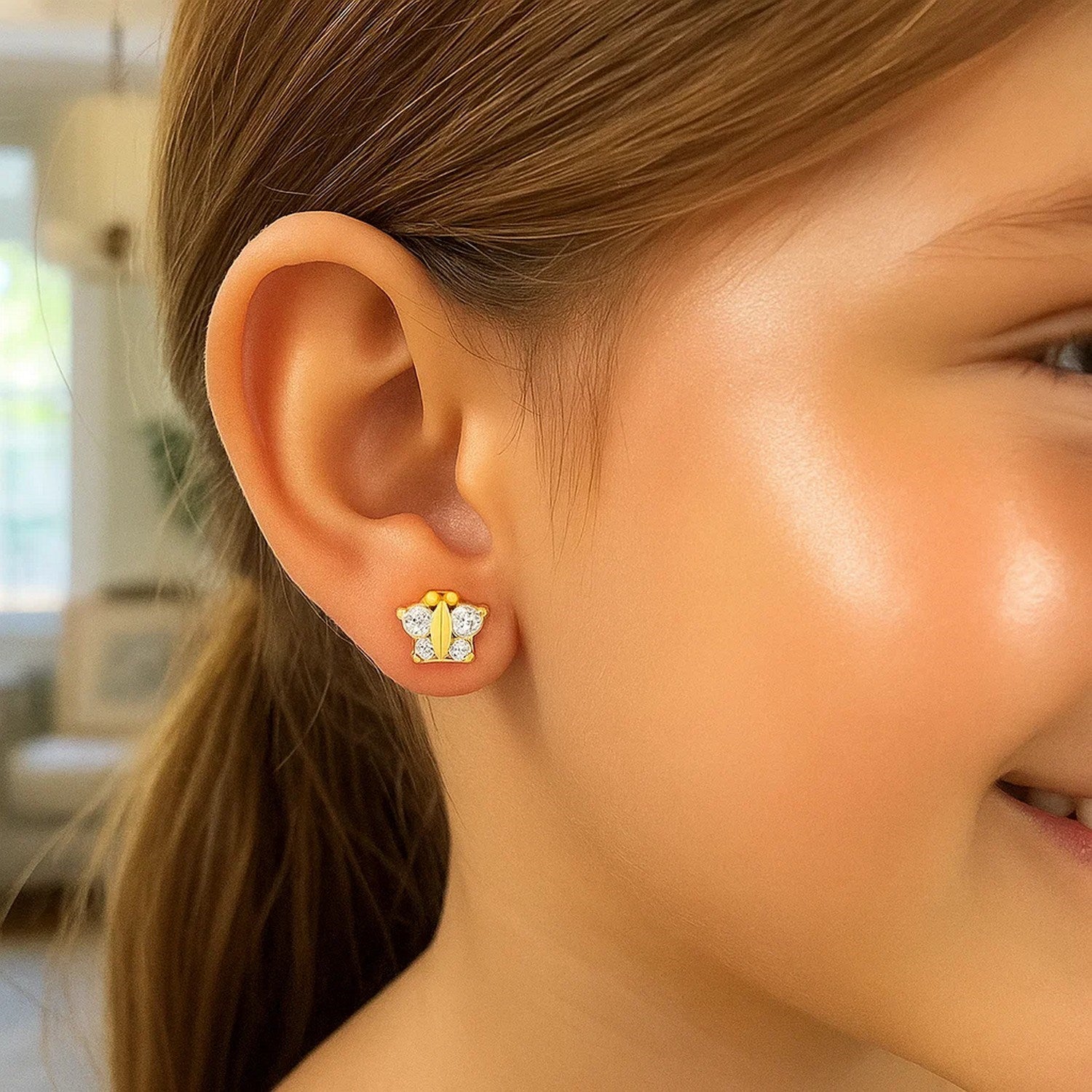 14k yellow gold butterfly stud earrings for children, featuring a modern design and secure stud backing.