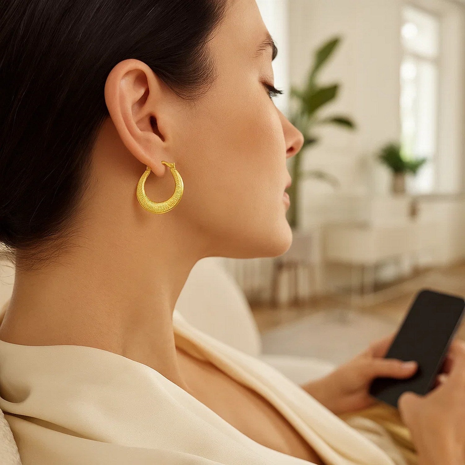 14k yellow gold textured hoop earrings showcasing an elegant round design, perfect for sophisticated occasions.