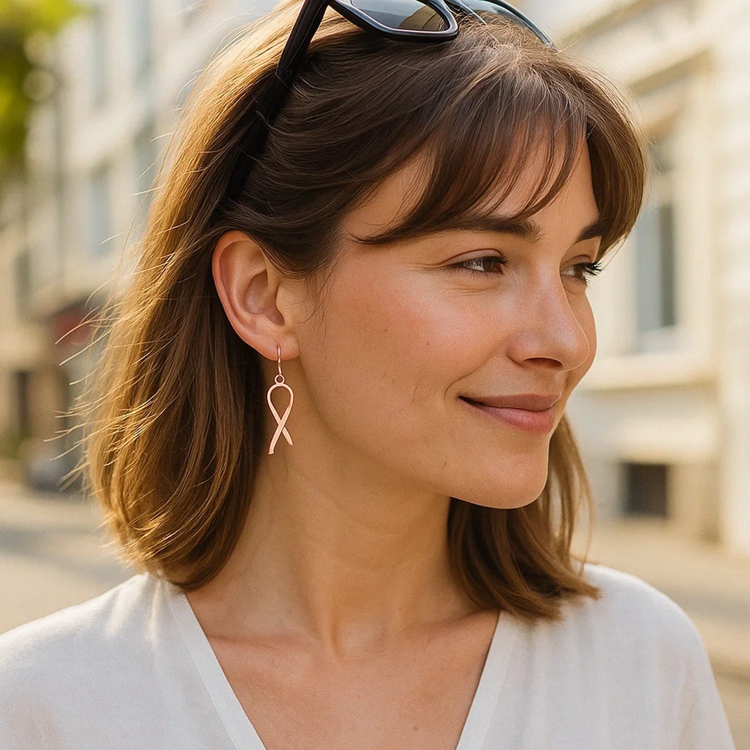 14k rose gold polished ribbon drop earrings showcasing an elegant design with a luxurious shine and graceful movement.