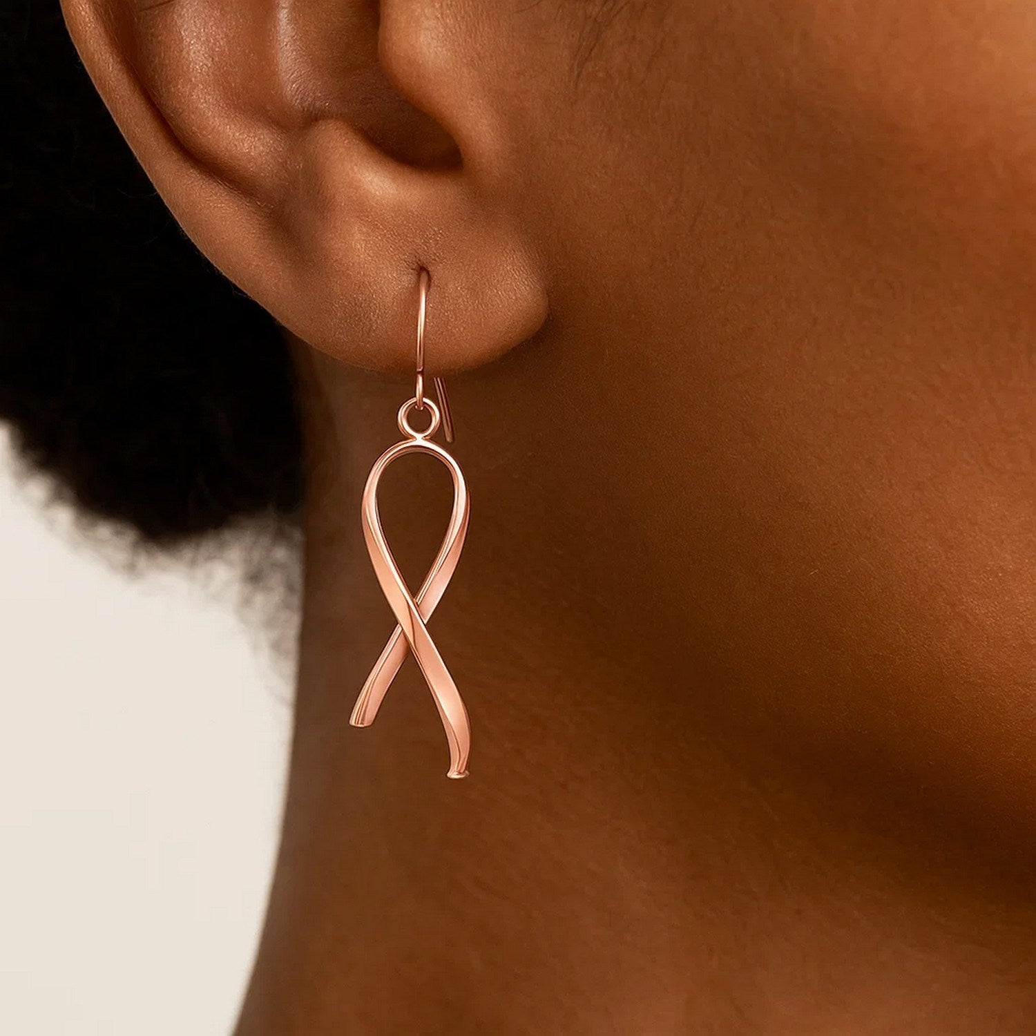 14k rose gold polished ribbon drop earrings exuding elegance with a refined design and luxurious finish.