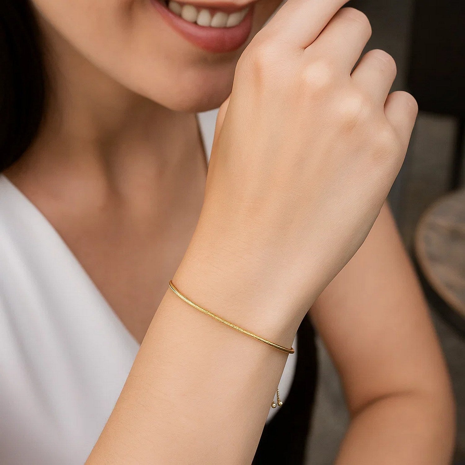 14k yellow gold adjustable lariat bracelet featuring a modern heart motif and delicate chain design.