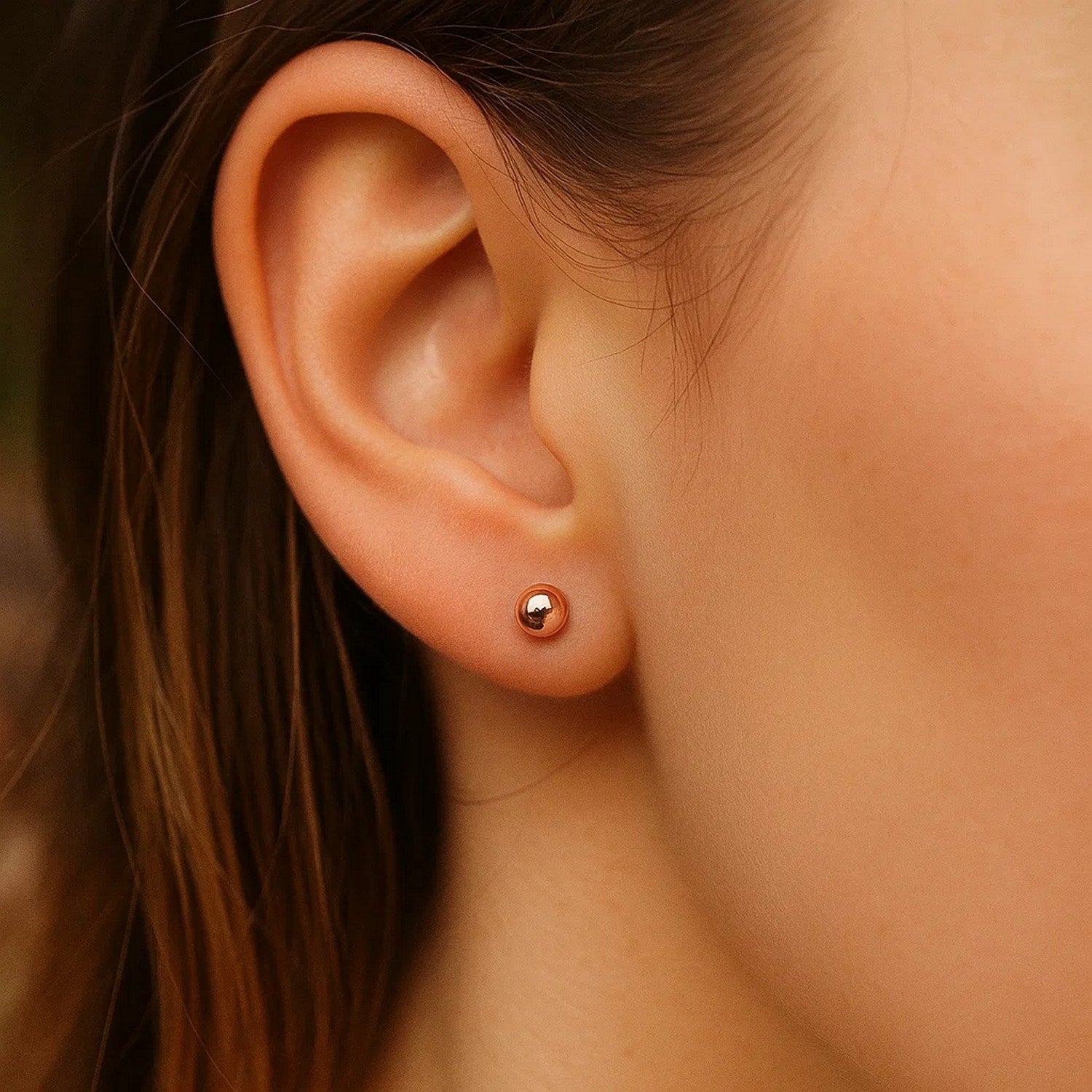 14k rose gold polished ball style stud earrings, showcasing elegant simplicity and timeless luxury.